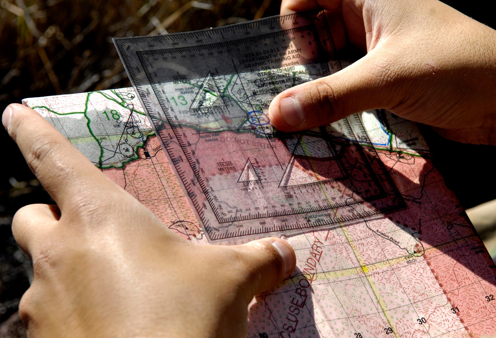 Staff Sgt. George Earhart plots coordinates on a range map Oct. 23 at the Pohakuloa Training Area, Hawaii. Sergeant Earhart is a tactical air controller from the 25th Air Support Operations Squadron, Wheeler Army Air Field, Hawaii. (U.S. Air Force photo/Tech. Sgt. Shane A. Cuomo)