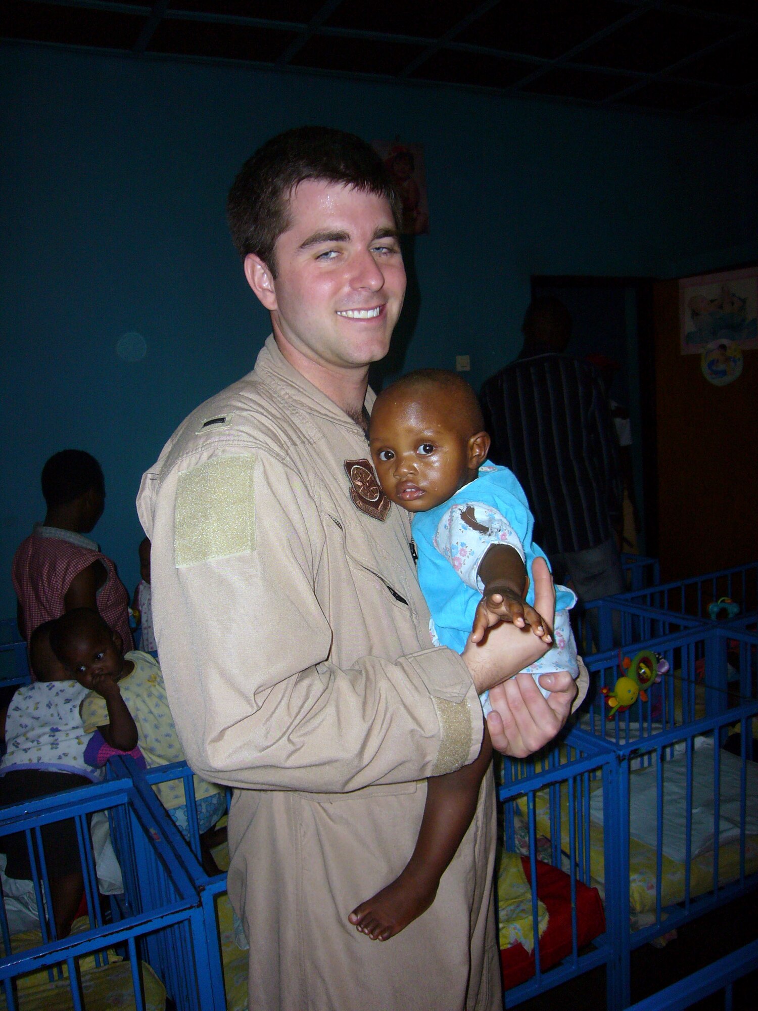 1st Lt. Andy Conwell, 786th Air Expeditionary Squadron C-17 pilot, holds a baby at an orphanage in Kigali, Rwanda, Oct. 27. Lieutenant Conwell was part of a group of Airmen who visited the orphanage and donate items for the children. (U.S. Air Force photo/Capt. Erin Dorrance)
