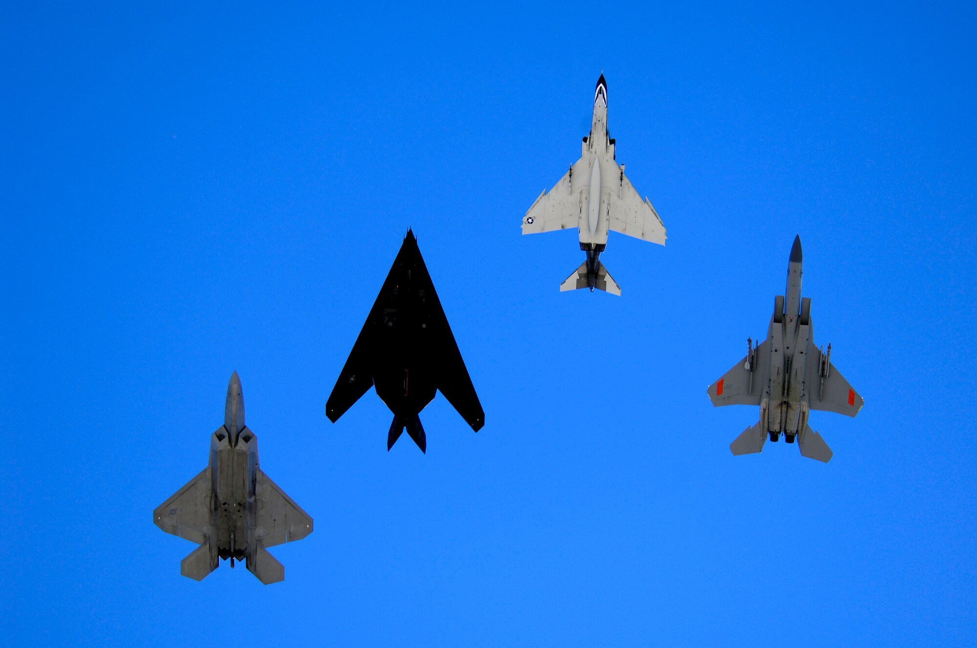 An F-22 Raptor, an F-117 Nighthawk, an F-4 Phantom and an F-15 Eagle fly over Holloman Air Force Base, N.M. Oct. 27 during the Holloman Air and Space Expo.  The expo showcased Air Force capabilities and the 49th Fighter Wing.  (U.S. Air Force photo/Staff Sgt. Jason Colbert)