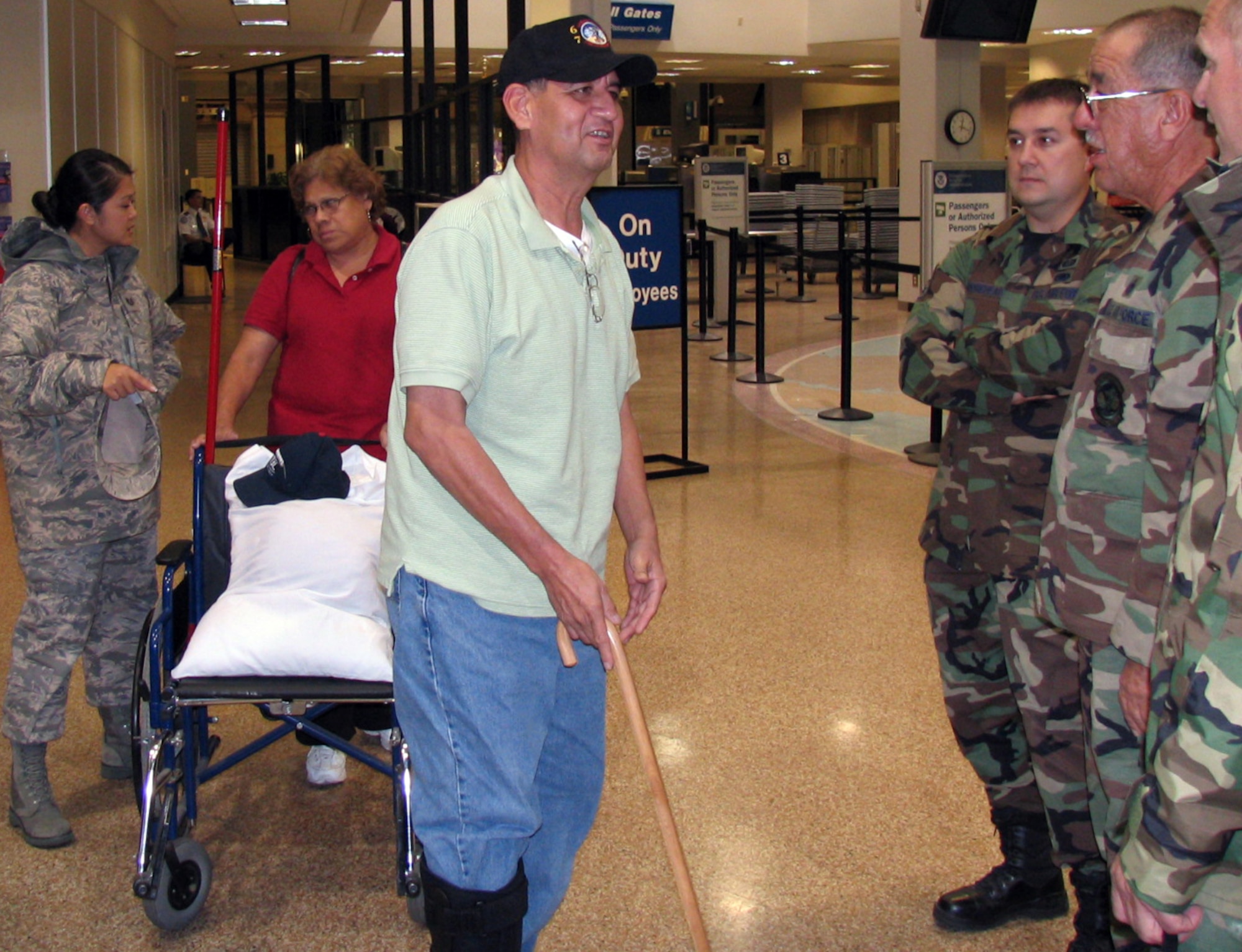 Tech. Sgt. Alfredo Vasquez, of the 67th Aerial Port Squadron, is greeted by wing personnel at the Salt Lake International Airport, Oct. 18.  Sergeant Vasquez returned home after being hospitalized at Wilford Hall Medical Center, Lackland Air Force Base, Texas, for nearly five months after his leg was crushed by a pallet while he was deployed to Afghanistan. Sergeant Vasquez has endured nearly 20 surgeries and a grueling physical therapy program. (Courtesy Photo) 