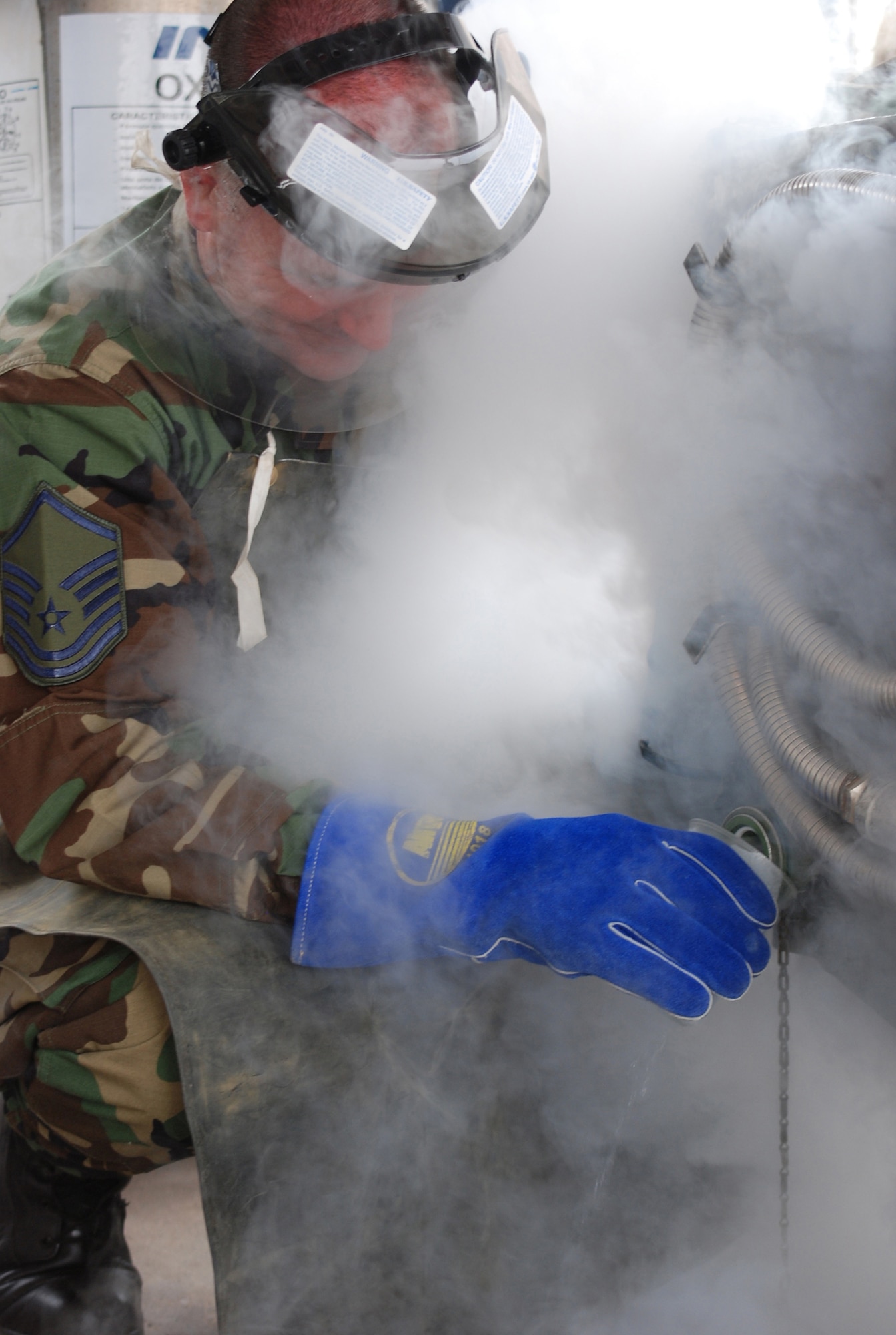 Master Sgt. Lawrence Rimmmer, 301st Maintenance Squadron fuels compliance chief was demonstrating to a Chilean counterpart how to do a quality sample test for liquid oxygen so that they could assist in servicing the lox carts for the Texas F-16s.  (U.S. Air Force Photo/Laura Dermarderosian-Smith)