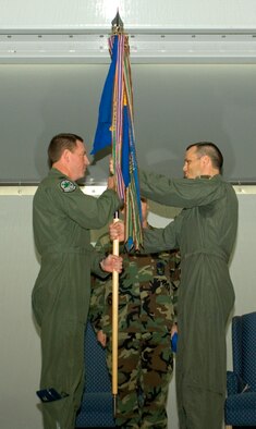 Col. James Hecker, 3rd Operations Group commander, presents the 525th Tactical Fighter Squadron flag to Lt. Col. Chuck Corcoran, 525th Fighter Squadron commander. Colonel Corcoran assumed command of the 525th FS during an activation ceremony here Monday. The squadron was inactivated as the 525th TFS in 1992. (Photo by Airman 1st Class Tinese Treadwell)