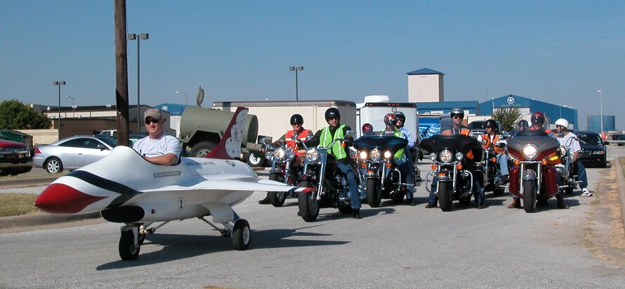 Motorcycle enthusiasts gather to begin the procession down to the Family Day Picnic at the base marina where prizes were awarded to the best of the best. Col. Kevin Pottinger, 301st Fighter Wing commander, led the pack following just behind the Air Force Reserve recruiters F-16 mock jet car. (U.S. Air Force Photo/Tech. Sgt. Stephen Bailey)