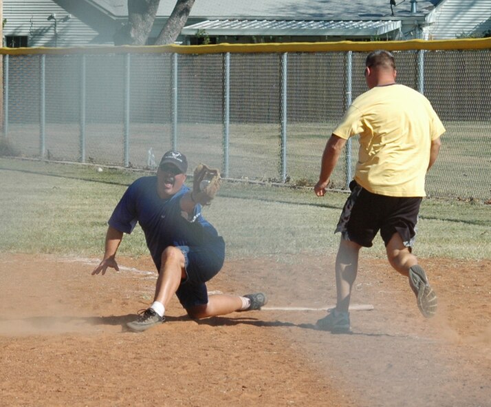 Mark Godfrey, 301st Maintenance Squadron "Crewdogs" team captain, catches a base hit during one of the games which lead them into this year's Softball Tournament Champions. They beat the 73rd APS team 15-9. (U.S. Air Force Photo/Chief Master Sgt. Bob Chura)