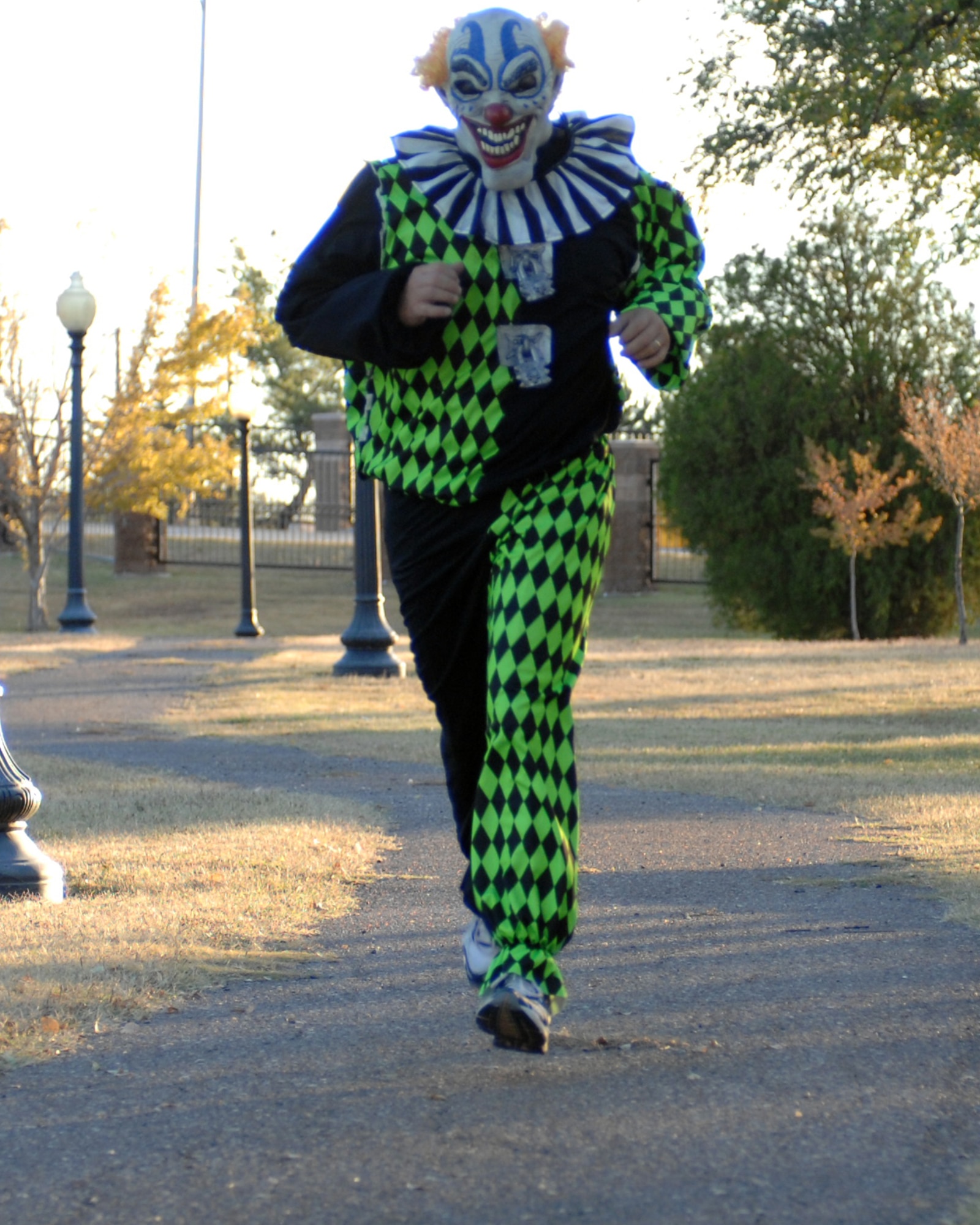 CANNON AIR FORCE BASE, N.M. -- Senior Master Sgt. Patrick Fry, 27th Special Operations Services Squadron, dressed as a clown, makes his way into the last stretch of the Spooky 5K run held here Tuesday. Sergeant Fry was awarded first place for best costume.(U.S. Air Force photo by Airman 1st Class Evelyn Chavez)