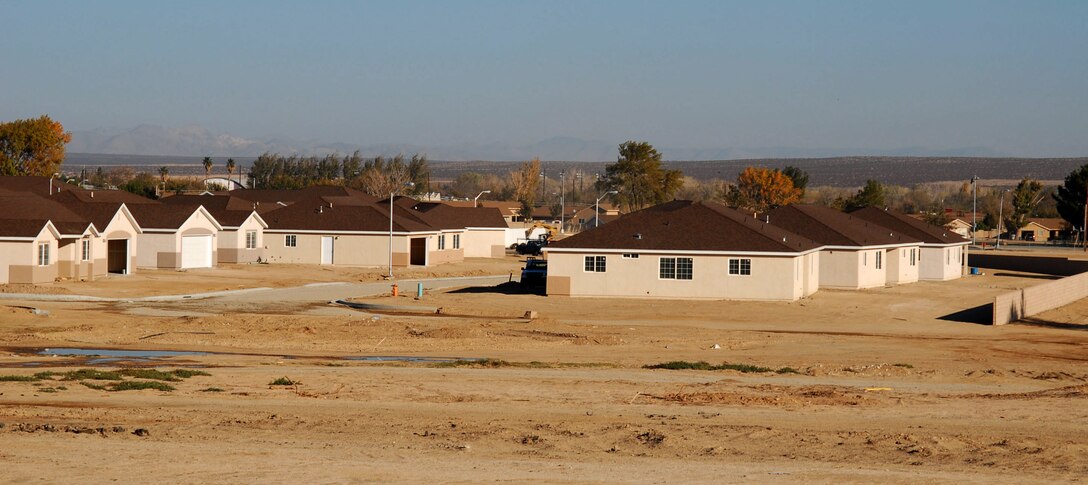 Contractors put the finishing touches on new housing units in the Tamarisk Plains housing area here. One hundred homes were demolished in the area to make way for 236 new homes and a large community park. (Photo by Airman 1st Class Mike Young)