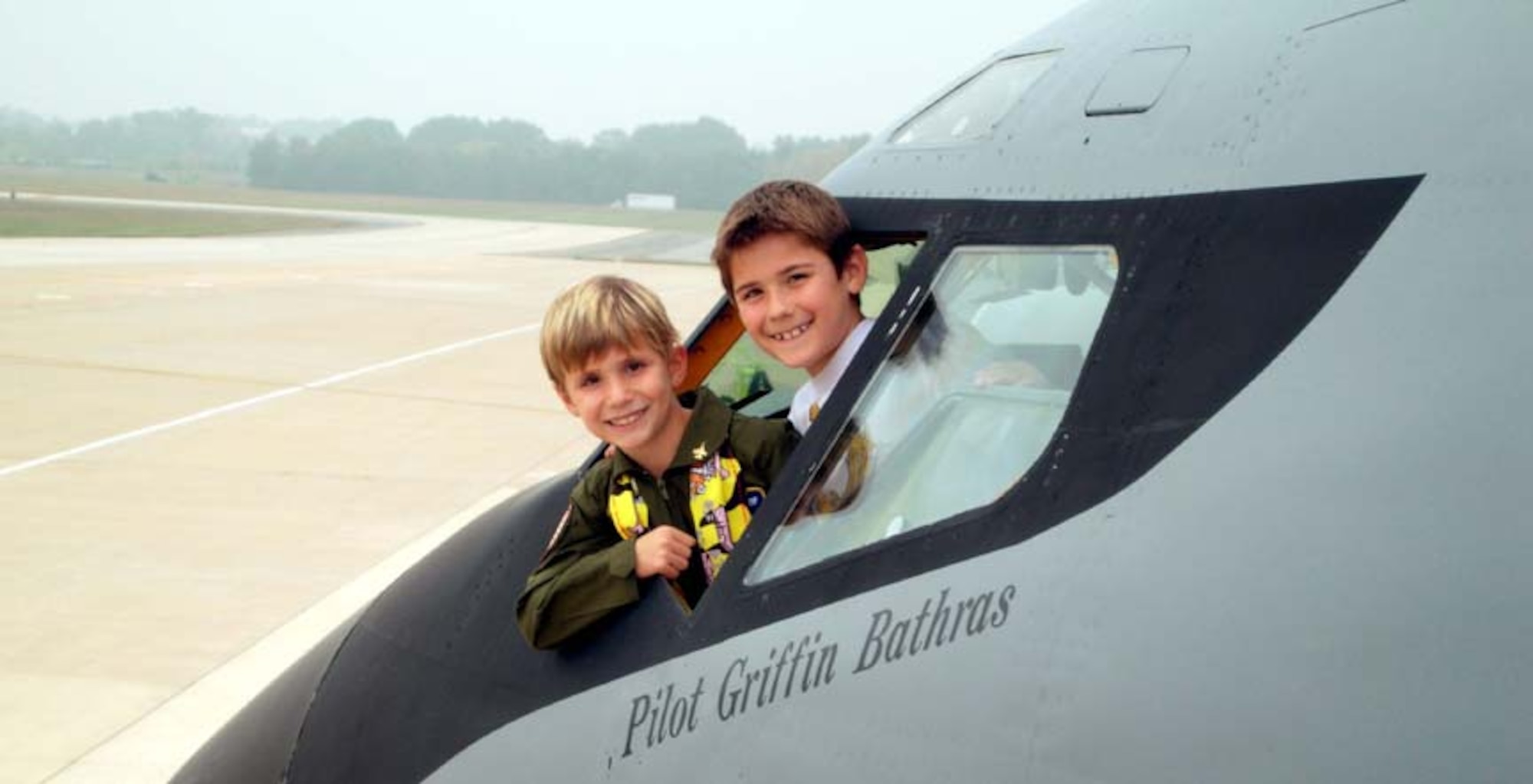 ANDREWS AIR FORCE BASE, Md. -- (Foreground) Griffin Bathras, 7, and his brother Camden, 9, smile from the cockpit of a KC-135 tanker jet during their tour here Oct. 4. Griffin was the guest of honor as part of the D.C. Air National Guard and 459th Air Refueling Wing joint venture "Pilot for a Day" here Oct. 4. The outreach program offers aircraft and squadron tours, lunch and full accommodations for children with serious or chronic conditions. The child also receives a personal pilot flight suit as he or she takes the pilot's oath. (U.S. Air Force photo/Staff Sgt. Amaani Lyle)