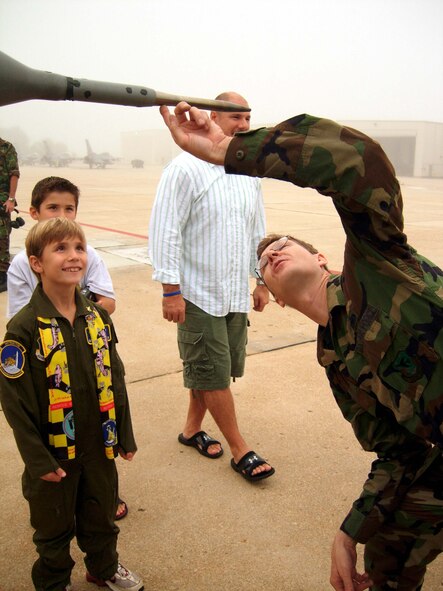 ANDREWS AIR FORCE BASE, Md. -- (Foreground) Griffin Bathras, 7, and his brother Camden, 9,watch as  Master Sgt. Ron Owens, DC ANG 113th Wing avionics specialist, explains the design of an F-16 fighter jet. The tour is part of the D.C. Air National Guard and 459th Air Refueling Wing joint venture "Pilot for a Day" here Oct. 4. The outreach program offers aircraft and squadron tours, lunch and full accommodations for children with serious or chronic conditions. The child also receives a personal pilot flight suit as he or she takes the pilot's oath. (U.S. Air Force photo/Staff Sgt. Amaani Lyle)