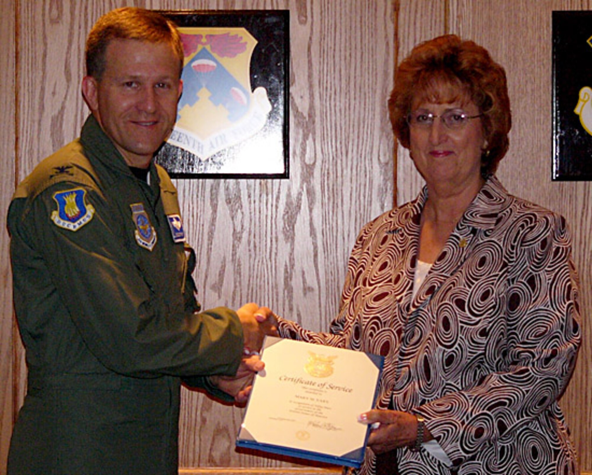 Col. John Zazworsky presents Mary Eary, the 22nd Mission Support Group executive secretary at McConnell Air Force Base, Kan., with a certificate of service and pin for her 50 years of service as a civil service member. Colonel Zazworsky is the acting 22nd Air Refueling Wing commander.  (courtesy photo) 