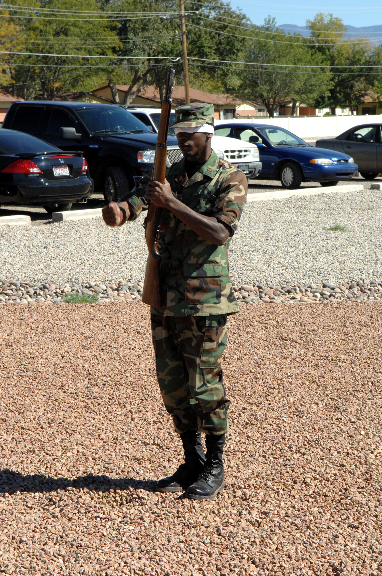 2nd Lt. Brandon Sanders, 49th Civil Engineer Squadron and upcoming Honor Guard member, spins a rifle blindfolded for Brig. Gen. David Goldfein, 49th Fighter Wing commander, before the unveiling of the new Honor Guard trailer. (U.S. Air Force photo/Senior Airman Anthony Nelson)