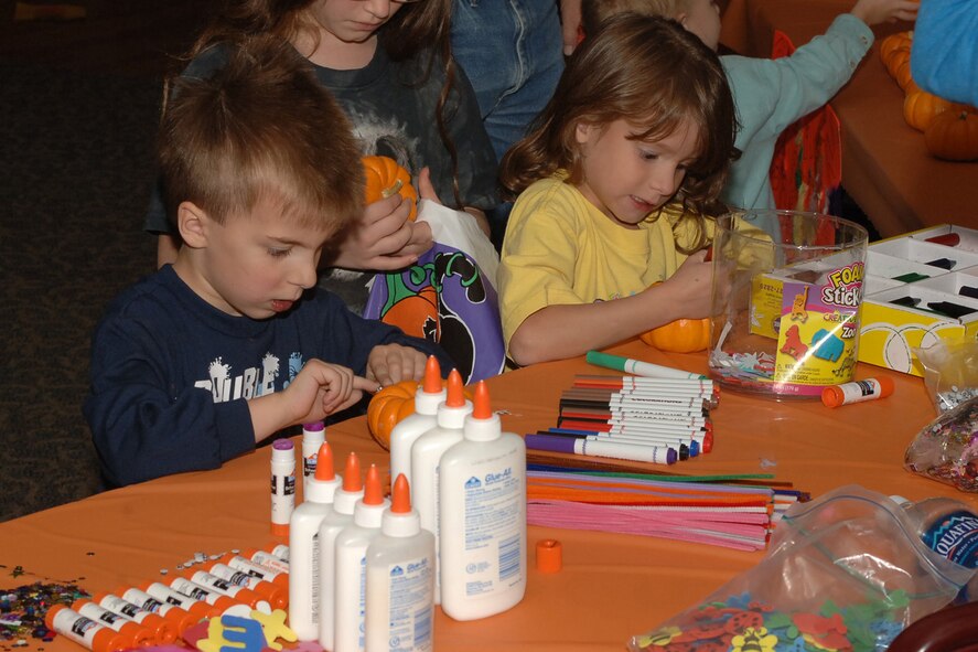 DYESS AIR FORCE BASE, Texas-- Eric Bares (4), son of 1st Lt. Anthony Bares from the 9th Bomb Squadron, along with Rachel Garrison, daughter of Staff Sgt. Patrick Garrison from the 7th Maintenance Squadron, decorate their very own pumpkins at the fall festival held at the heritage club here on base October 26. The festival also included events such as cupcake decorating, face painting and many different activities. (U.S Air Force photo by Airman 1st Class Felicia Juenke)