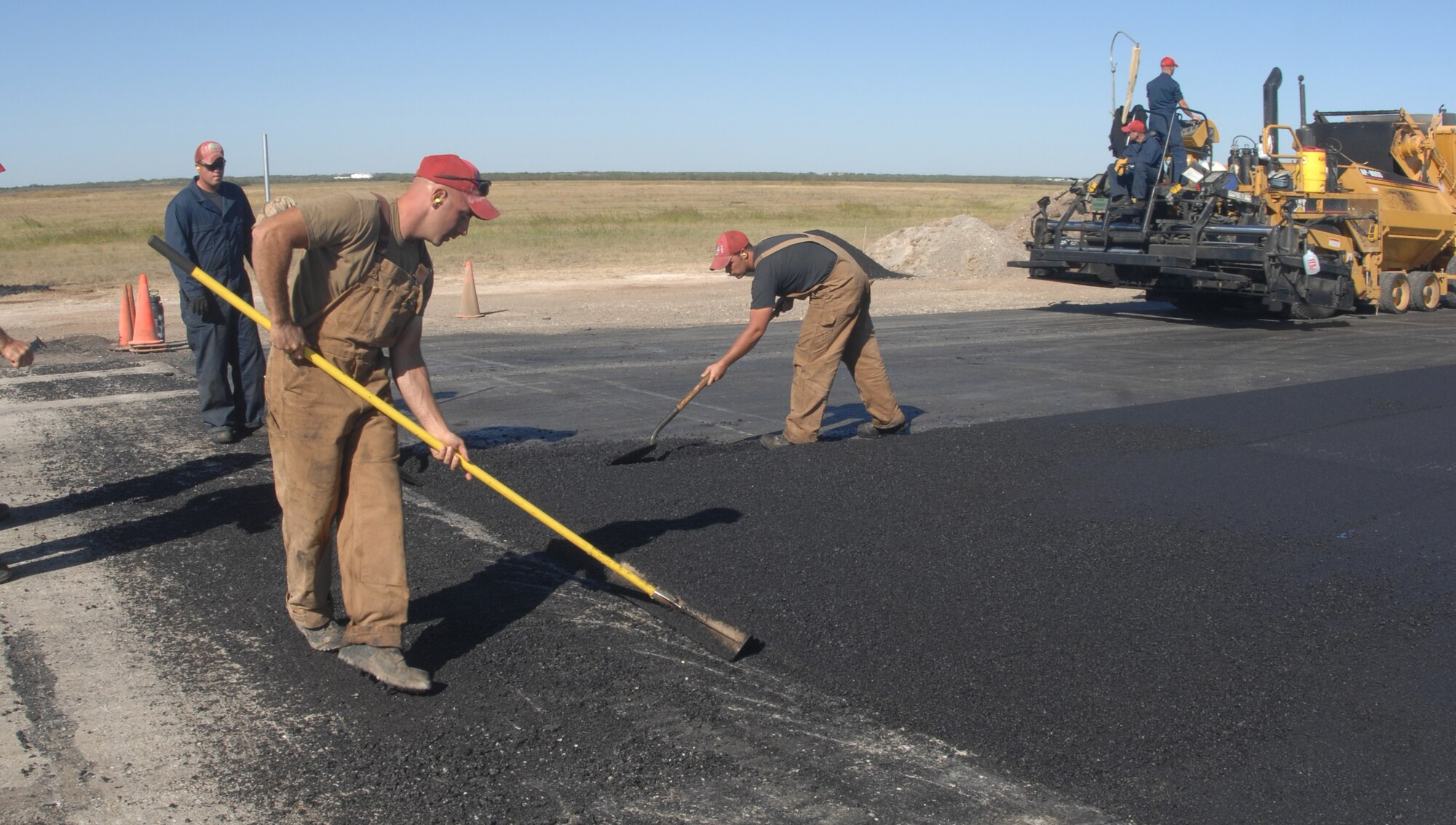 REDHORSE team members repave Dyess' runway Oct. 18 while the base B-1s are deployed. The work REDHORSE does here and around the Air Force trains them to deploy in support of the Global War on Terror. (U.S. Air Force photo by Airman 1st Class Felicia Juenke)