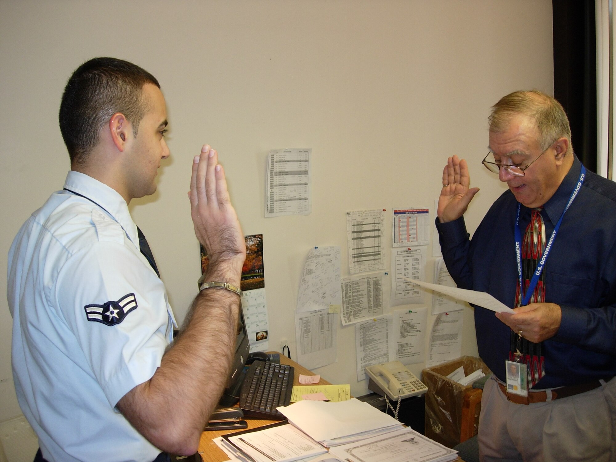HANSCOM AFB, Mass. -- Airman First Class Zana Hikmat (left), 66th Mission Support Squadron Orderly Room personnelist, swears in to become a U.S. citizen at the John F. Kennedy building in Boston, Mass. Airman Hikmat, originally from the city of Sulaimaniya in northern Iraq, moved to the United States with his family when he was 14 years old.  Fulfilling his dream of finishing his education and making a difference in the War on Terror, Airman Hikmat became a member of the Air Force in 2006. (U.S. Air Force photo by Airman 1st Class Albert Lewis.)

