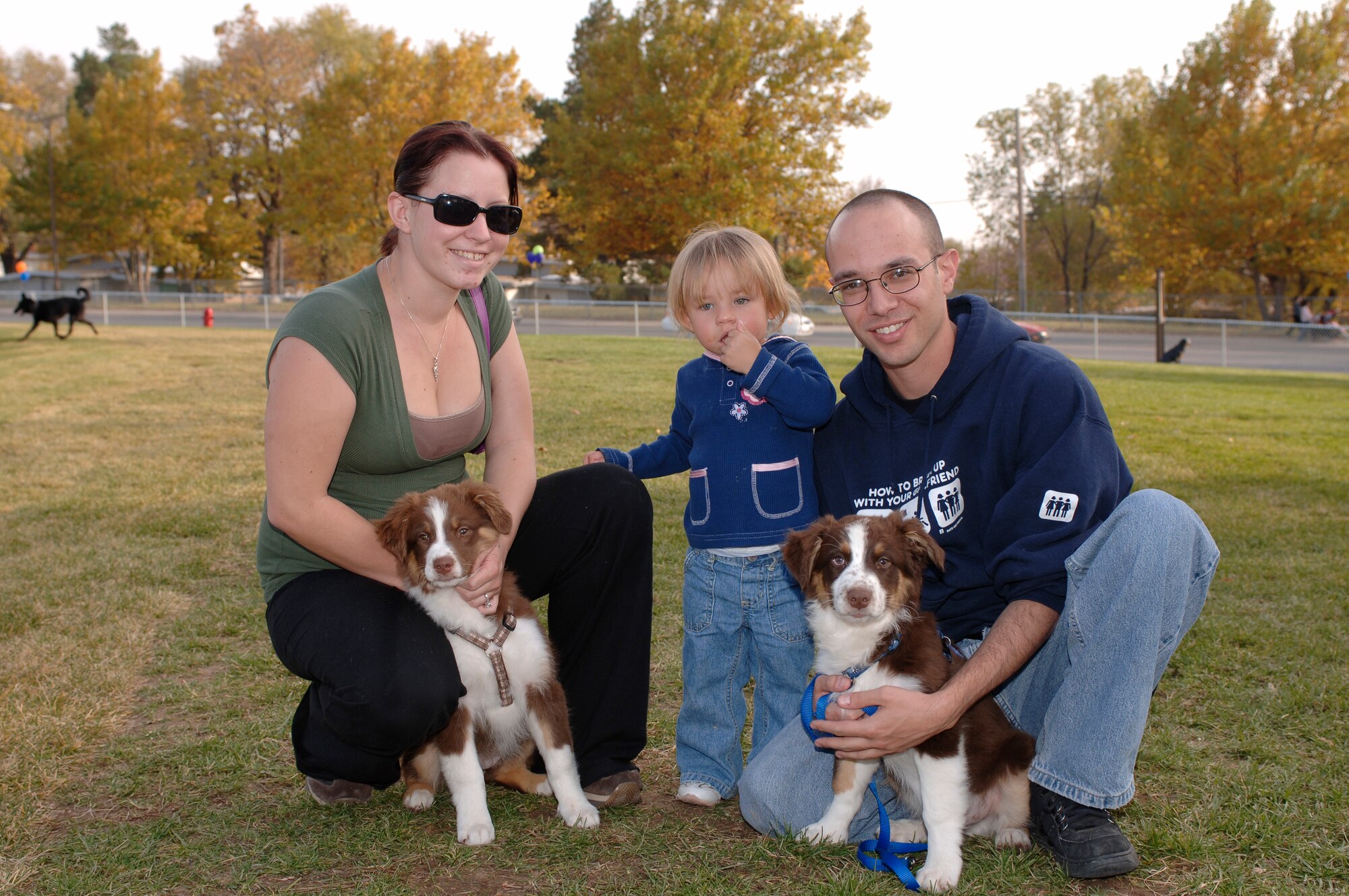 HILL AIR FORCE BASE, Utah-- (Left to Right) Jennifer Hartmayer, Mackenzie Hartmayer and Staff Sgt. David Hartmayer, 388th Component Maintenance Squadron, attend the grand opening of the Hill AFB Dog Park. They are accompanied with their two Austrialian Sheppards. (U.S. Air Force photo by Todd Cromar)