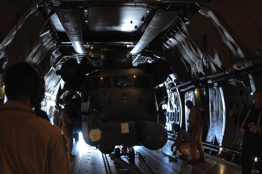 With literally inches of wiggle room, a 352nd Maintenance Squadron team of 10 Airmen load a 21st Special Operations Squadron MH-53M Pave Low IV helicopter on a C-5 Galaxy headed to the 'Boneyard,' Oct. 5, 2007. Officially known as the Aerospace Maintenance and Regeneration Group in Tucson, Ariz., the 'Boneyard' will eventually store all five Pave Lows assigned to RAF Mildenhall due to the aircraft's retirement. (U.S. Air Force photo by Tech. Sgt. Tracy L. DeMarco)