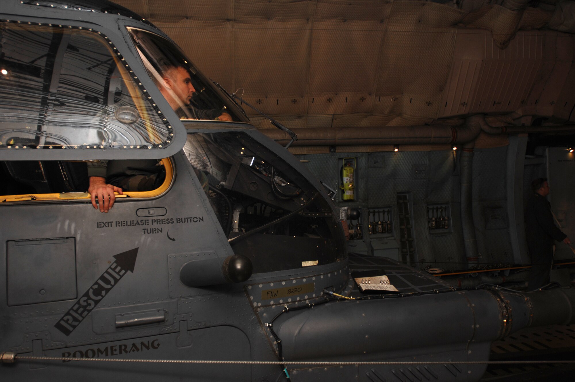 With literally inches of wiggle room, 'brake rider,' Senior Airman Kevin Roth, from the 352nd Maintenance Squadron, assists in loading a 21st Special Operations Squadron MH-53M Pave Low IV helicopter, onto a C-5 Galaxy from Travis Air Force Base, Calif. Each time the 352nd MXS load team and C-5 crew suspected a clearance problem during the load, Airman Roth applied the helicopter brakes ensuring all members involved remained safe as each situation was reviewed and resolved.(U.S. Air Force photo by Tech. Sgt. Tracy L. DeMarco)
