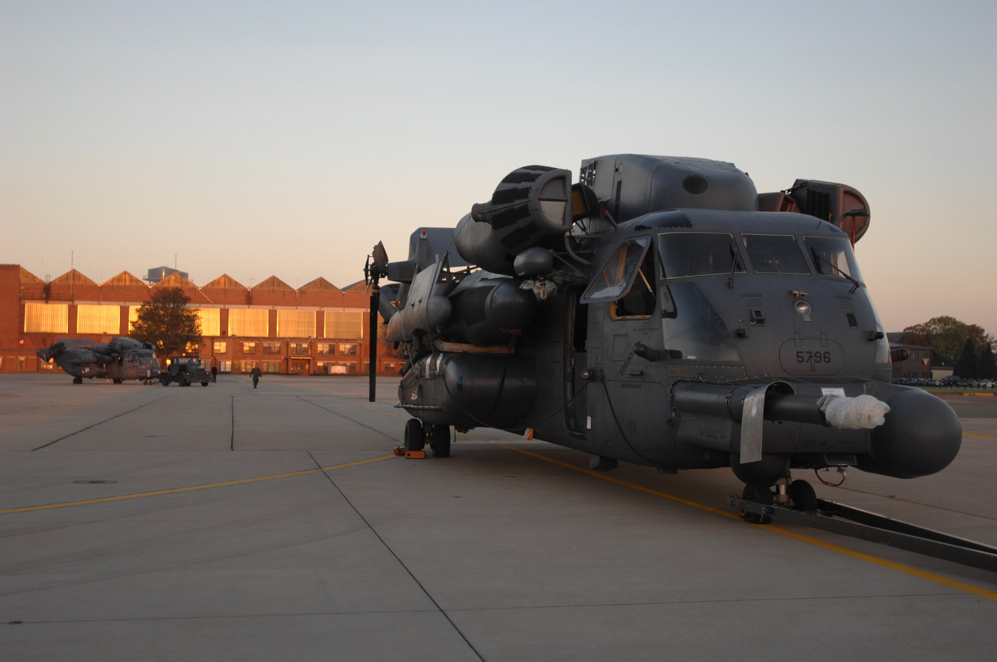 Stripped of their rotor blades, two MH-53M Pave Low IV helicopters from the 21st Special Operations Squadron, RAF Mildenhall, are towed into the shadow of a C-5 Galaxy from Travis Air Force Base, Calif., which will take them to their final resting place at the Aerospace Maintenance and Regeneration Group in Tucson, Ariz., Oct. 5, 2007. The Pave Lows are being retired Air Force wide by October 2008, making room for the CV-22 Osprey. (U.S. Air Force photo by Tech. Sgt. Tracy L. DeMarco)