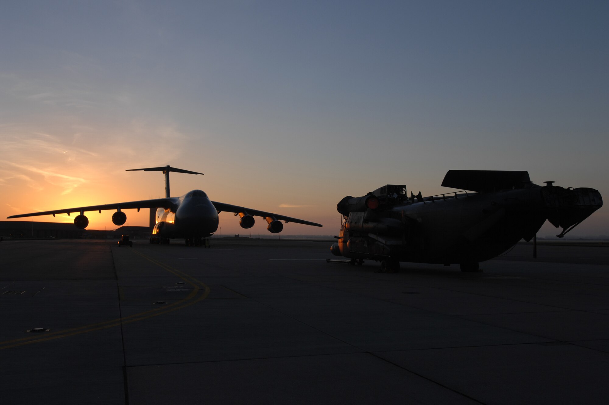 In the early morning hours, Oct. 5, 2007, a 21st Special Operations Squadron MH-53M Pave Low IV helicopter, destined for the 'Boneyard,' or the Aerospace Maintenance and Regeneration Group in Tucson, Ariz., waits to be loaded on a C-5 Galaxy from Travis Air Force Base, Calif., to be taken to its final resting place. (U.S. Air Force photo by Tech. Sgt. Tracy L. DeMarco)
