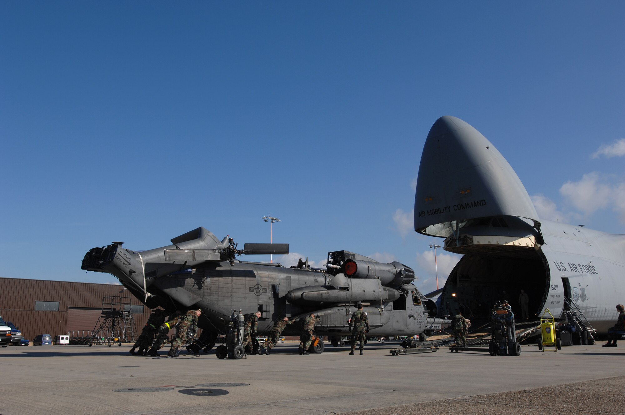 A load team from the 352nd Maintenance Squadron along with the crew of a C-5 Galaxy from Travis Air Force Base, Calif., loads a 21st Special Operations Squadron MH-53M Pave Low IV helicopter to be transported to the 'Boneyard,' or the Aerospace Maintenance and Regeneration Group in Tucson, Ariz., Oct. 5, 2007.
(U.S. Air Force photo by Tech. Sgt. Tracy L. DeMarco)
