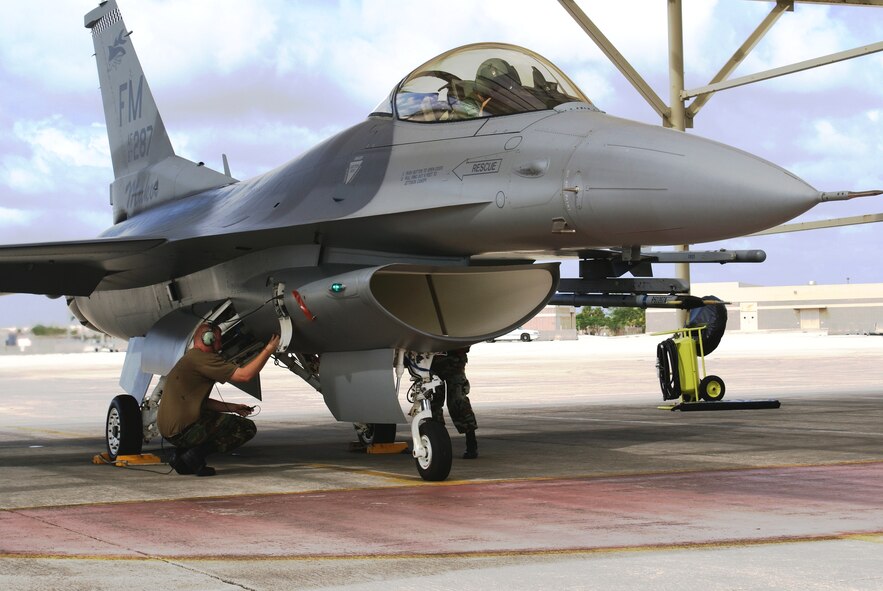 Maintenance personnel from the 482nd Fighter Wing, Homestead Air Reserve Base, Fla., perform pre-flight inspections on an F-16 prior to departure Oct. 30, 2007.  A total of 24 F-16 fighter jets left Homestead ARB for Dobbins Air Reserve Base, Ga., as part of preparations for Tropical Storm Noel.  The early evacuation allows pilots and maintenance personnel to return home to south Florida in time to care for their families before a storm.  The movement of jets is a precaution to protect this valuable national asset. (U.S. Air Force photo/Tim Norton)
