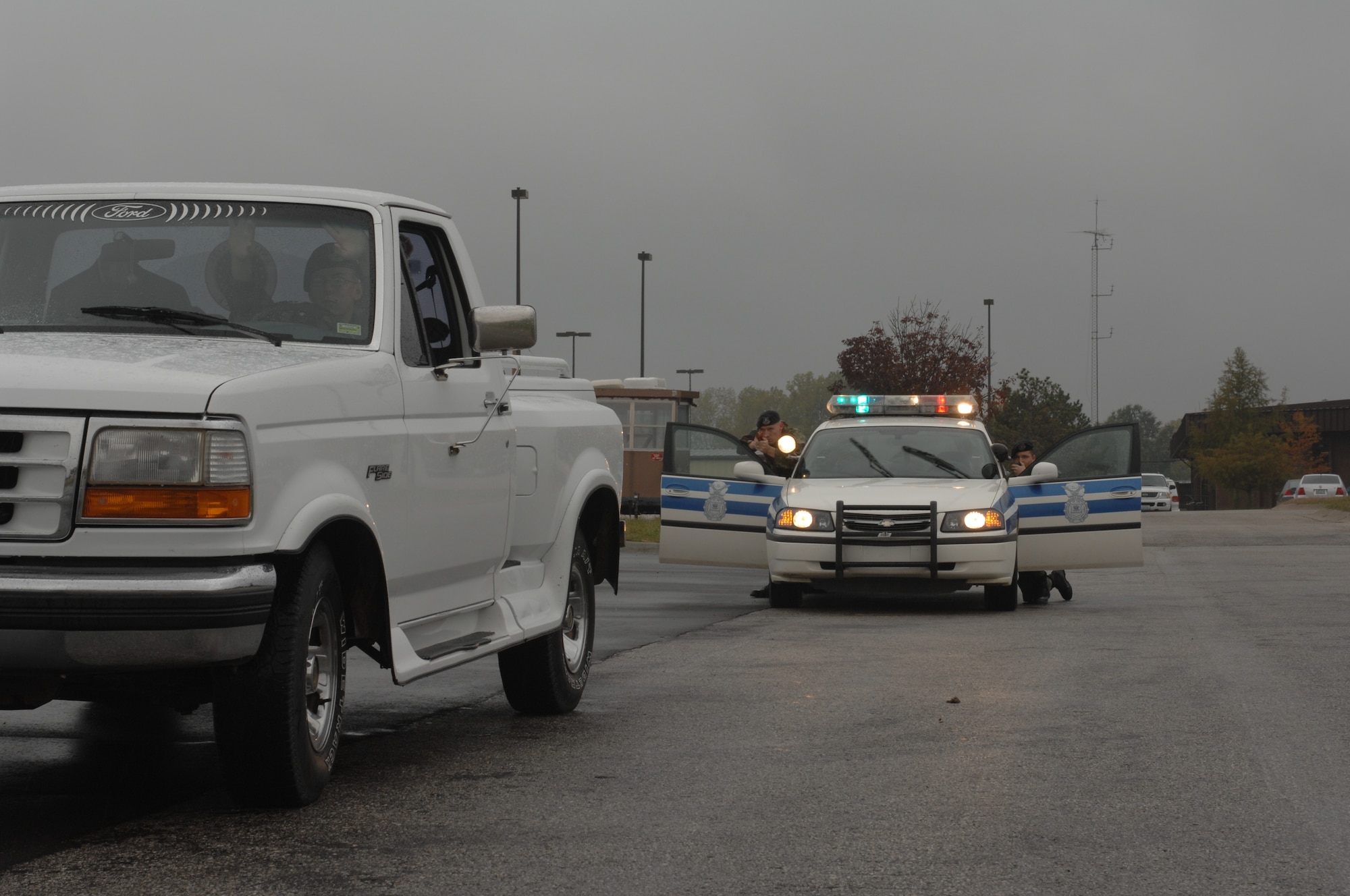 WHITEMAN AIR FORCE BASE, Mo. --  Senior Airman Michael Durso and Staff Sgt. Nicholas McCall, both from the 509th Security Forces Squadron, challenge Airman 1st Class Nathan Staas, 509th SFS, during a high-risk traffic stop scenario in a field- training exercise Oct. 26. (U.S. Air Force photo/ Airman 1st Class Jessica M. Snow)
