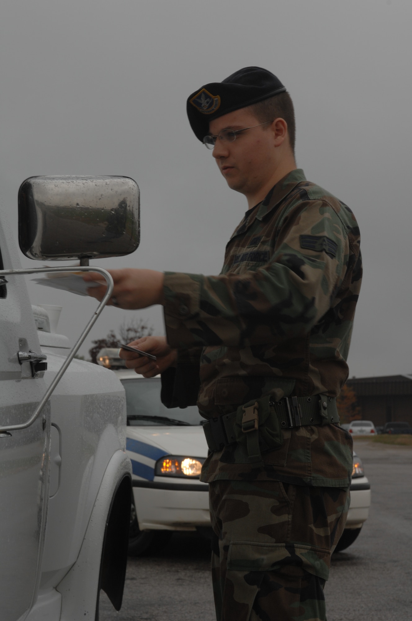 WHITEMAN AIR FORCE BASE, Mo. -- Senior Airman Michael Durso, 509th Security Forces Squadron, hands Airman 1st Class Nathan Staas, 509th SFS, documents, a drivers license, a military identification card, vehicle registration and proof of insurance during an exercise Oct. 26. (U.S. Air Force photo/ Airman 1st Class Jessica M. Snow)
