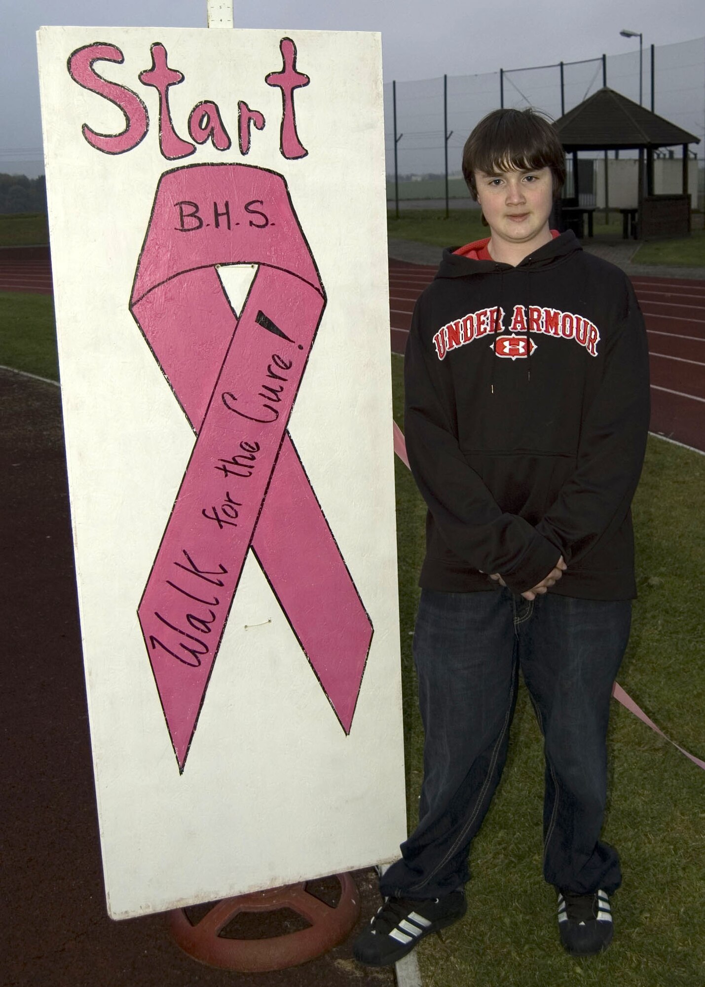 Cody Ray, Bitburg Middle School student, takes a moment to pose for a photo during the Walk for the Cure cancer awareness event. Ray was the first student to complete the first lap around the track. The goal of the event was to increase student awareness about breast cancer because one in eight women will be diagnosed with breast cancer in her lifetime. (U.S. Air Force Photo/Staff Sgt. Chris Mills)
