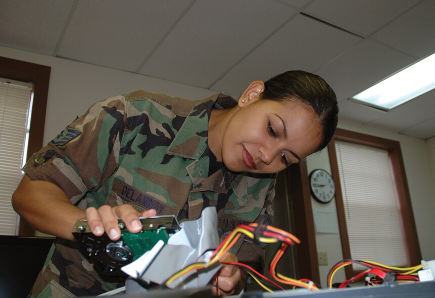 Staff Sgt. Dalia Delannoy, 919th Logistics Readiness Squadron material management journeyman, installs a hard drive into a computer for her unit's members. As an extra duty on unit training assembly weekends, Sergeant Delannoy typically installs patches into traditional reservists' computers to ensure they are in compliance with the Eglin Air Force Base network. Since patches are passed through the system weekly, it is vital to traditional reservists that computers on Duke Field are in compliance and operable when they are present for duty. (U.S. Air Force Photo/Jasmine DeNamur)