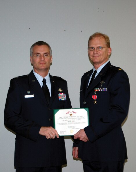 Maj. Kurt C. Workmaster (right), 919th Medical Squadron physician assistant, was awarded with the Bronze Star Medal for his efforts during a deployment in Afghanistan, where he helped the Afghan government extend its authority through projects and outreach programs. As the Panjshir Provincial Reconstruction Team physician assistant there, Major Workmaster treated Afghan patients in the local communities all the while working in a hostile environment. (U.S. Air Force Photo/Staff Sgt. Elizabeth Dunning)
