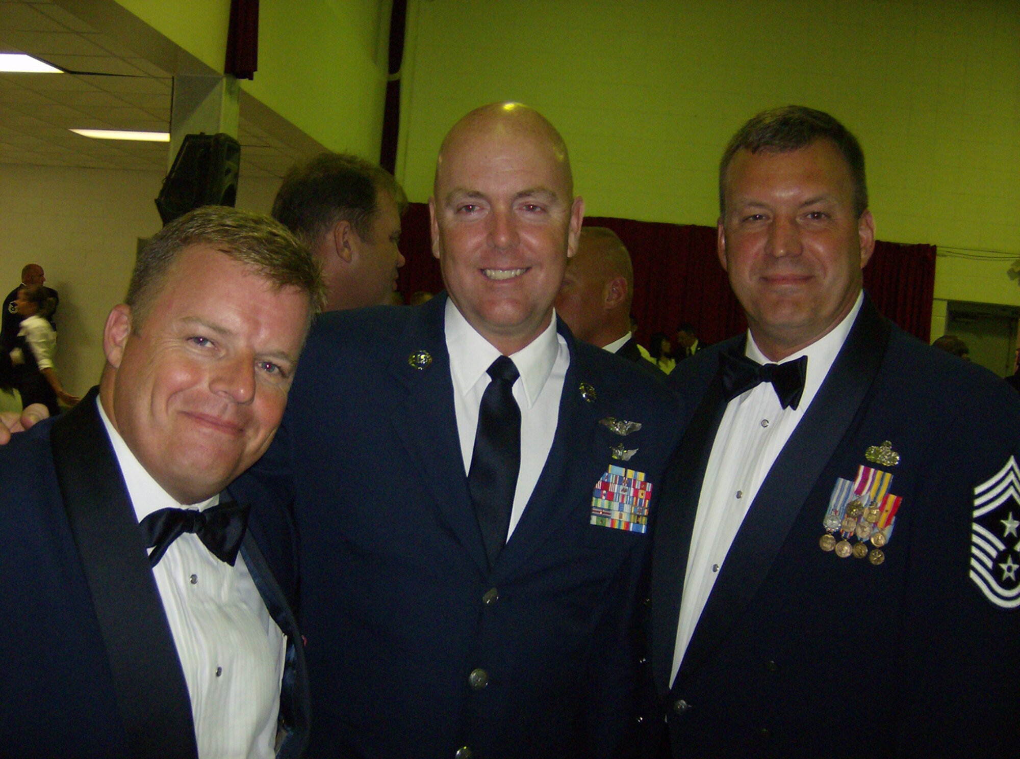 SEYMOUR JOHNSON AIR FORCE BASE, N.C. -- Master Sgt. BJ Somerville (middle), a boom operator with the 77th Air Refueling Squadron here, celebrates his graduation from the Senior Non-Commissioned Officer's Academy at Gunter AFB, Ala.  Showing support for his accomplishments are Master Chief Sgts. Sean Martin (left) and Lester Boltinhouse (right). All are members of the 916th Air Refueling Wing, Air Force Reserve.