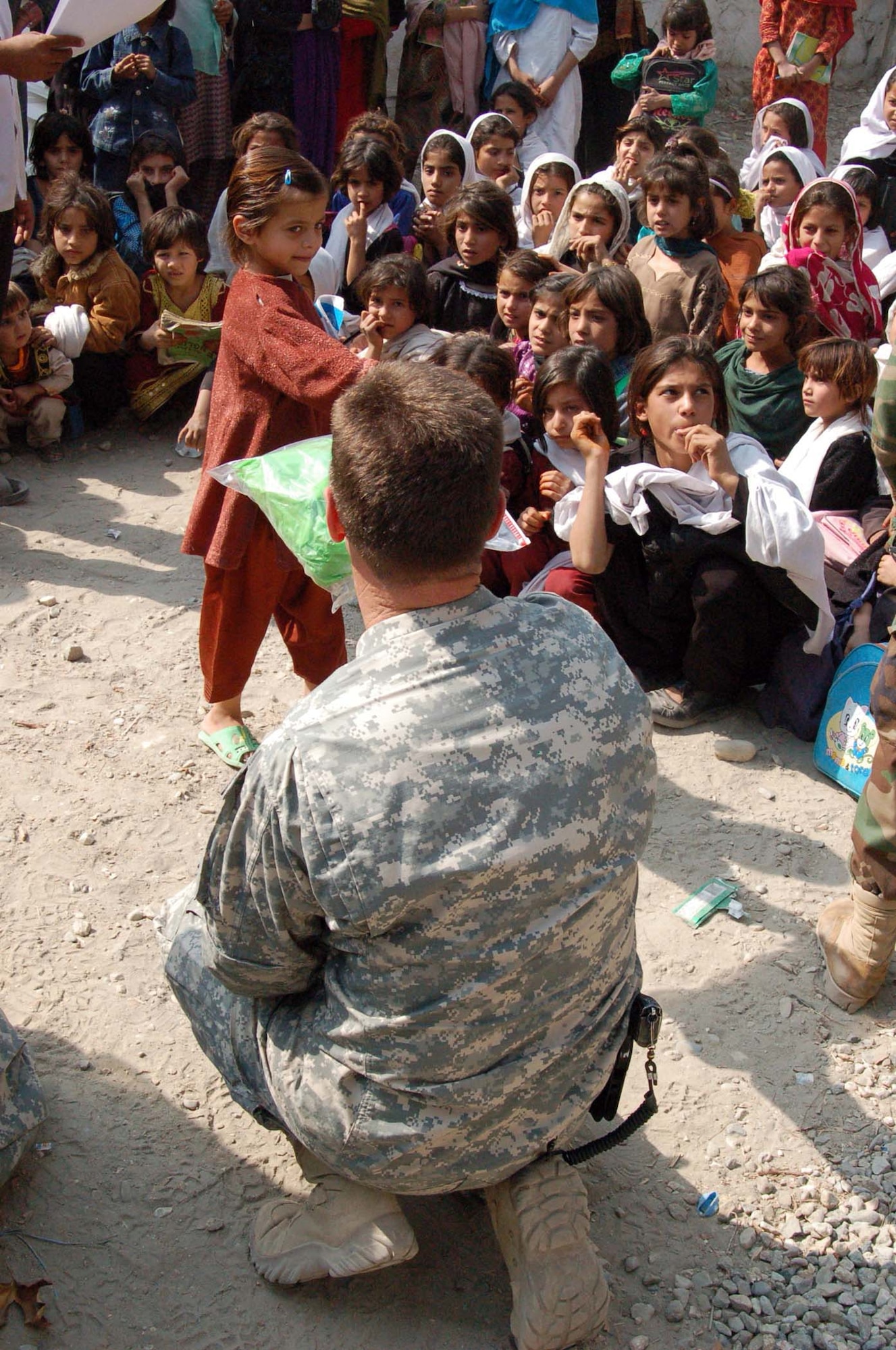 FORWARD OPERATING BASE FENTY, AFGHANISTAN -- An Afghan English language student is all smiles after receiving school supplies from Air Force Lt Col Gordon Phillips, Nangarhar Provincial Reconstruction Team commander.  The supplies were sent by U.S. Airmen at Kirtland AFB, New Mexico.  
(U.S. Air Force photo by Master Sgt Dean J. Miller)  
