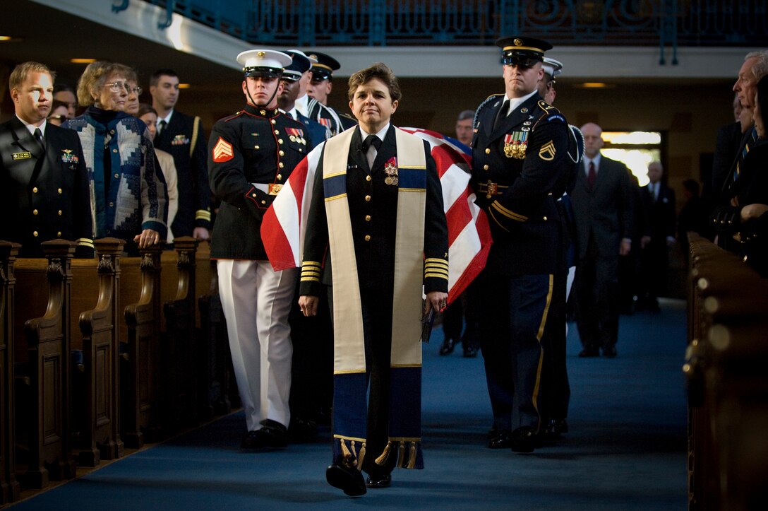 Navy Capt. Margaret G. Kibben, U.S. Naval Academy chaplain, leads the ceremonial honor guard carrying the casket of Adm. William J. Crowe, former chairman of the Joint Chiefs of Staff, into the academy chapel on Oct. 31, 2007, in Annapolis, Md.  Crowe, the 11th chairman, died Oct. 18 at the age of 82. 