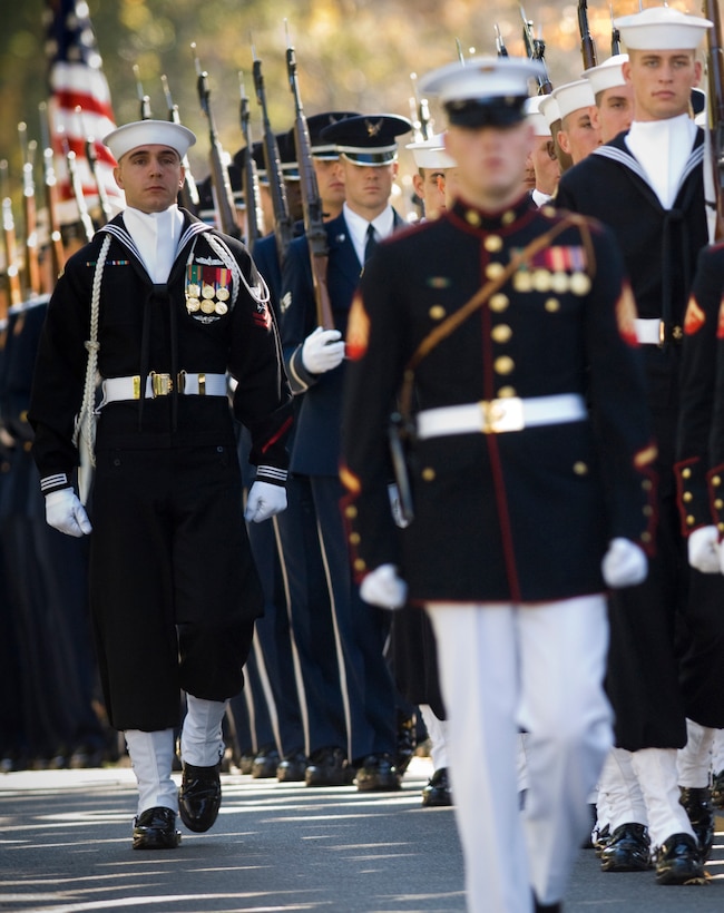 A joint service honor guard escorts the casket of Adm. William J. Crowe ...