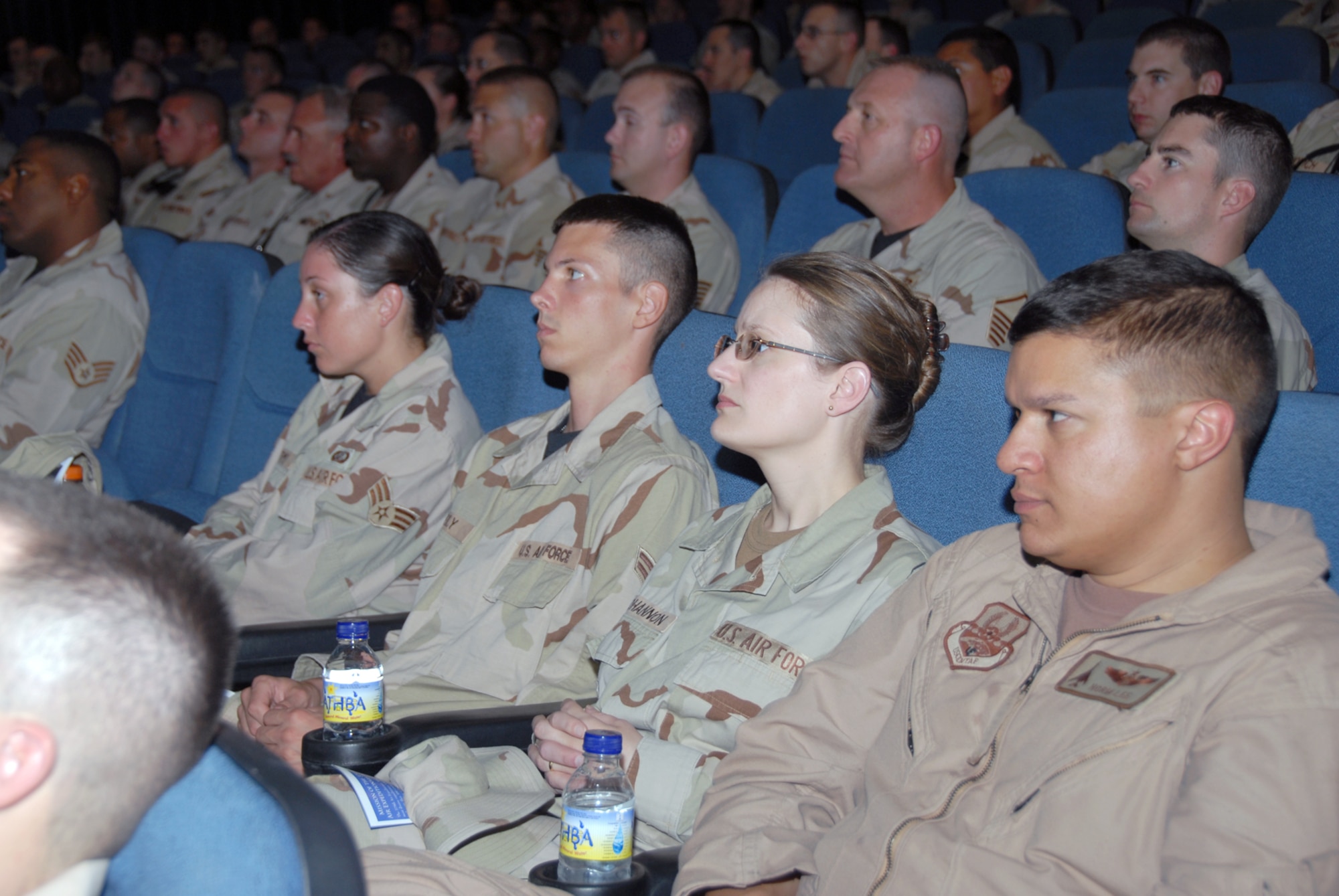 Airman with the 379th Air Expeditionary Wing listen to Brig. Gen. Charlie Lyon, 379th AEW commander, speak during a commander’s call. The briefings were held eight times last week and included information from the Airman Readiness Center and the chapel.  (U.S. Air Force photo by Airman 1st Class Ashley Tyler)