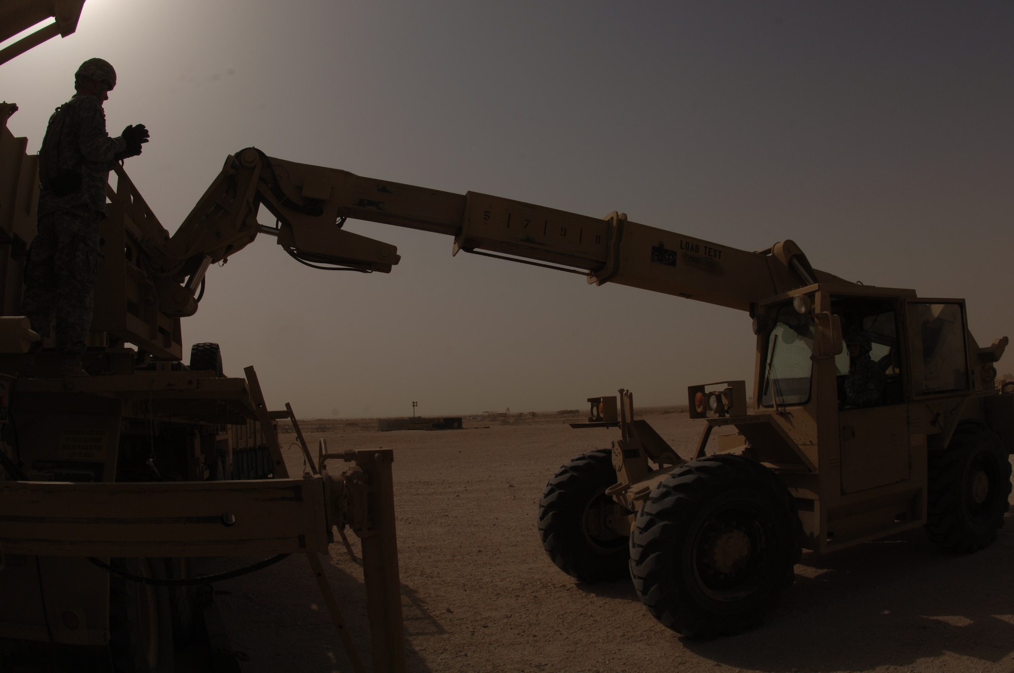 A Soldier with the 3/43rd Air Defense Artillery here directs a forklift as it prepares to replace a Patriot missile The 3/43rd ADA works hand in hand with the 71st Expeditionary Air Control Squadron to comprise the Command and Reporting Center, protecting the Desert Eagle Team’s personnel and assets.  (U.S. Air Force photo by Master Sgt. Ken Stephens)