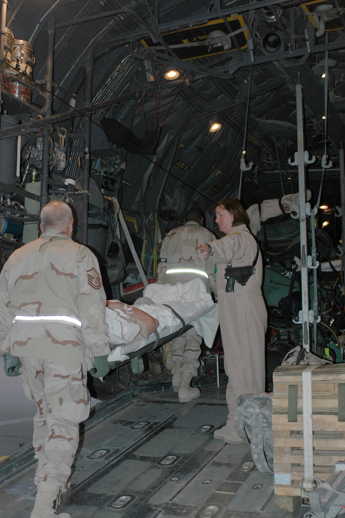 (Above) Airmen with the 379th Expeditionary Aeromedical Evacuation Squadron prepare to evacuate an injured servicemember at a forward deployed location in Iraq. The 379th EAES has flown more than 200 missions, transporting more than 600 patients. Support aircraft have transported more than 130,000 passengers and 74,000 tons of cargo.  (U.S. Air Force photo by Staff Sgt. Cassandra Locke)