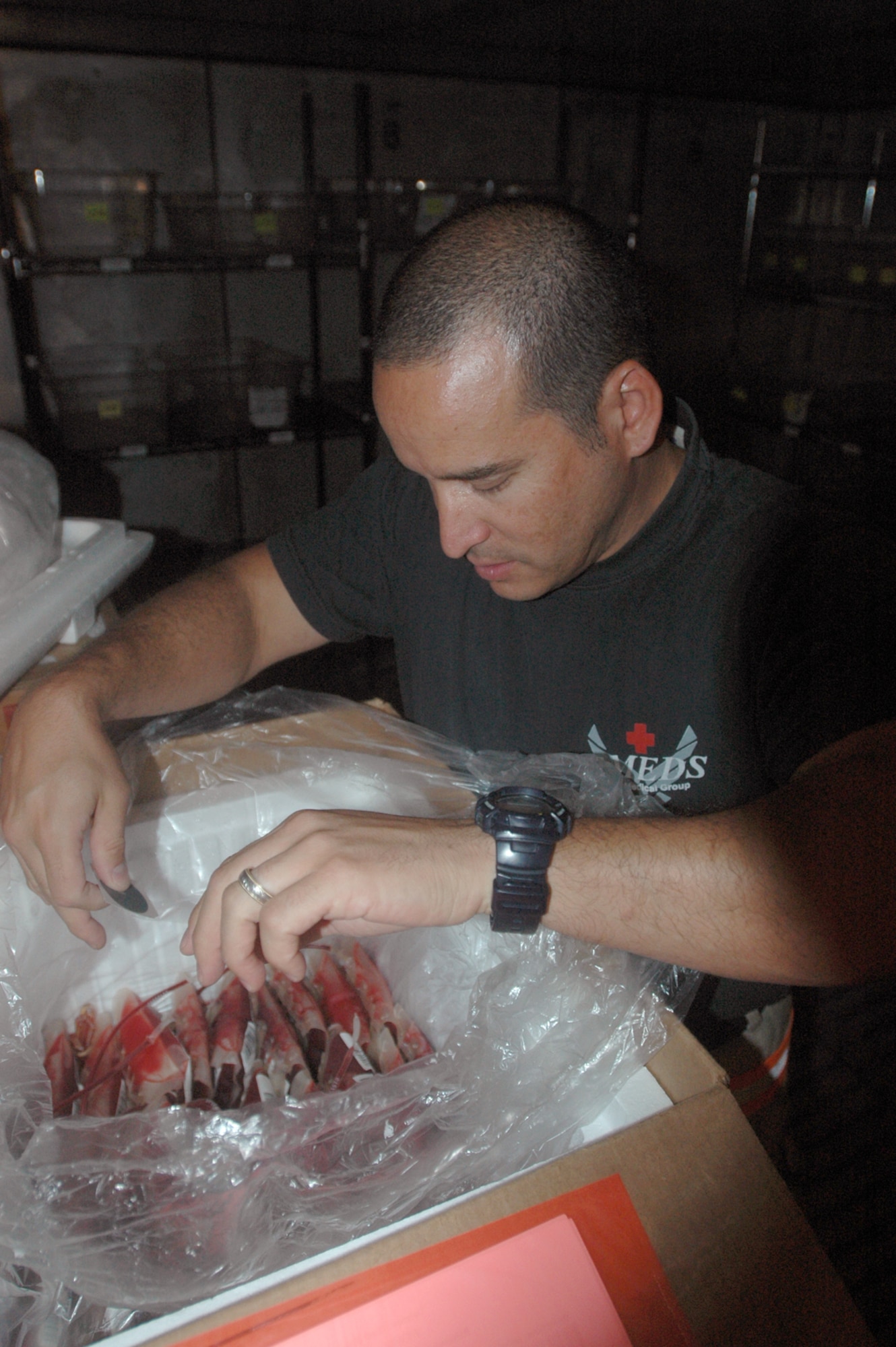 Tech. Sgt. John Joanidas, 379th Expeditionary Medical Group, sifts through blood components at the Blood Transshipment Center. The BTC supported 40 medical units by shipping 48 tons of blood products on 80 shipments, comprising 30,000 units worth $6.4 million.  (U.S. Air Force photo by Senior Airman Clark Staehle)