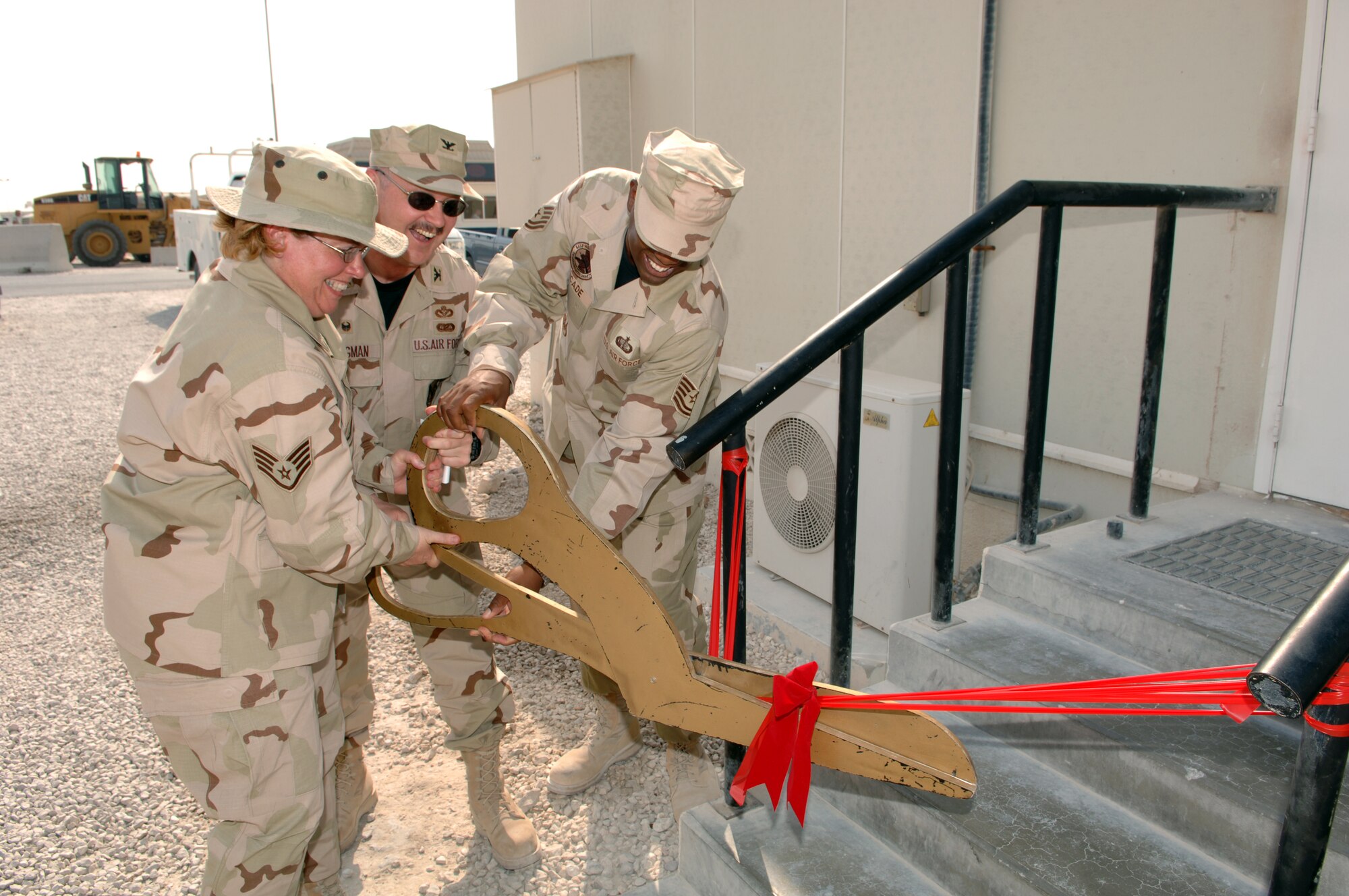Col. Shane Stegman, 379th Expeditionary Mission Support Group commander (center) unveils the new media center here. The unit operates the largest contracting squadron in the Air Force, which holds 1,400 contracts worth $20 million. The group also developed a local virtual outprocessing system, saving more than 60,000 man hours a year. (U.S. Air Force photo by Airman 1st Class Ashley Tyler)