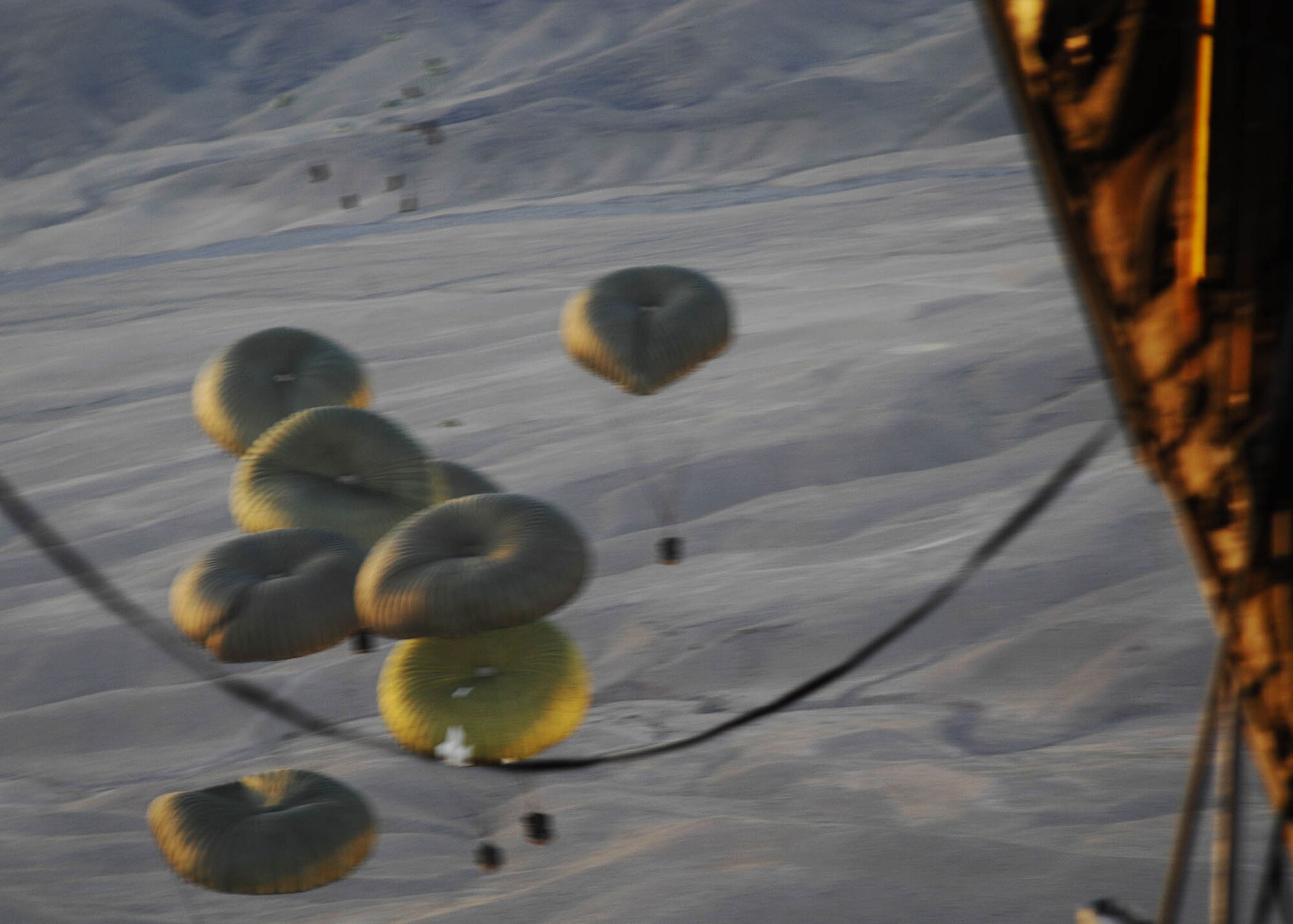 Supplies are airdropped from a C-130 Hercules to troops in the field by the 774th Expeditionary Airlift Squadron from Bagram Arifield, Afghanistan. The airdrop crew are Air National Guard from the 165th Airlift Wing from Louisville, Ky., and the 109th Airlift Wing from Schenectady, N.Y. (U.S. Air Force photo by Senior Master Sgt. Kim Allain)