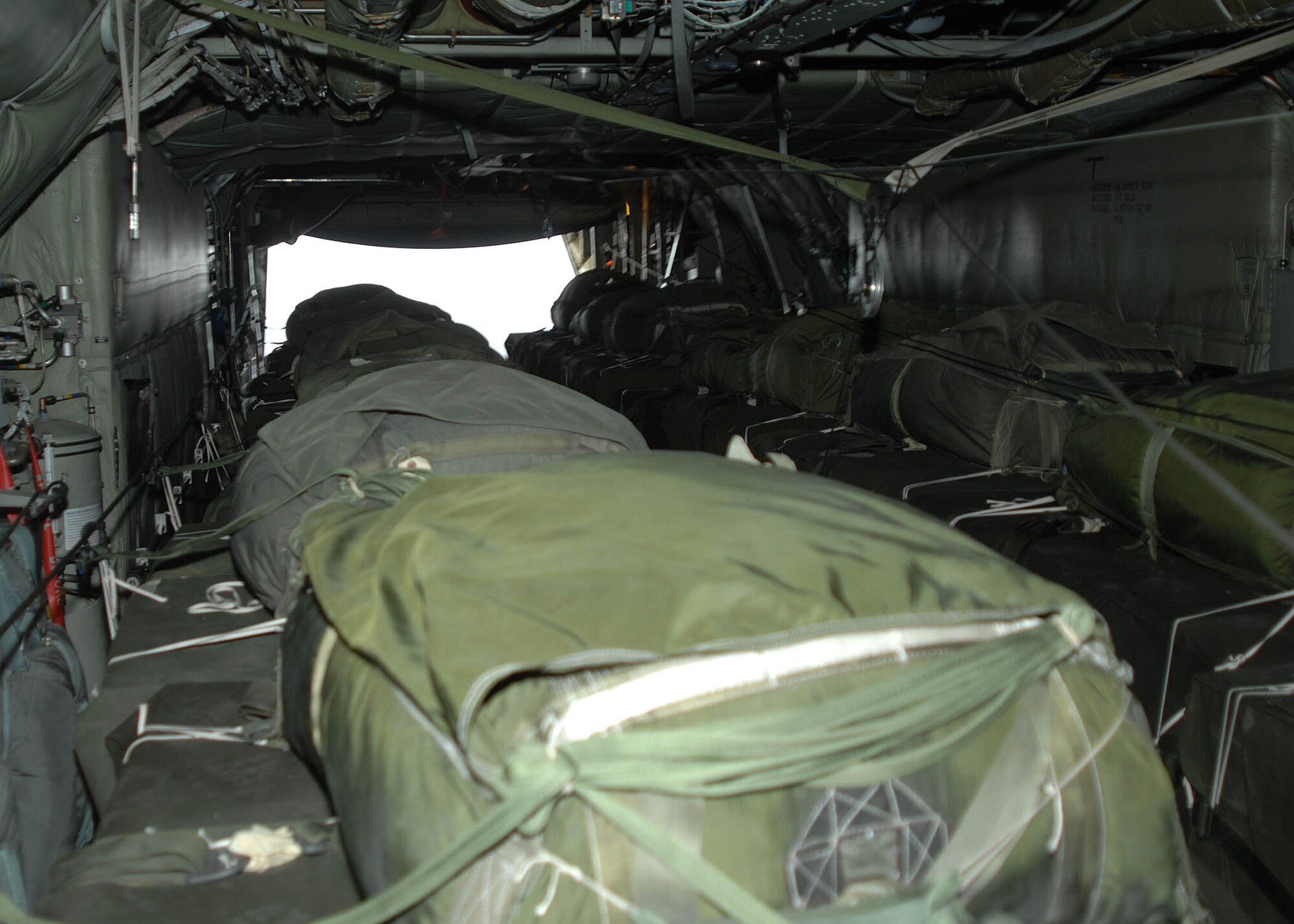 The ramp cargo door opens over a drop zone to release bundles of supplies being airdropped from a C-130 Hercules to troops in the field by the 774th Expeditionary Airlift Squadron from Bagram Arifield, Afghanistan. The airdrop crew are Air National Guard with the 165th Airlift Wing from Louisville, Ky., and the 109th Airlift Wing from Schenectady, N.Y. (U.S. Air Force photo by Senior Master Sgt. Kim Allain)