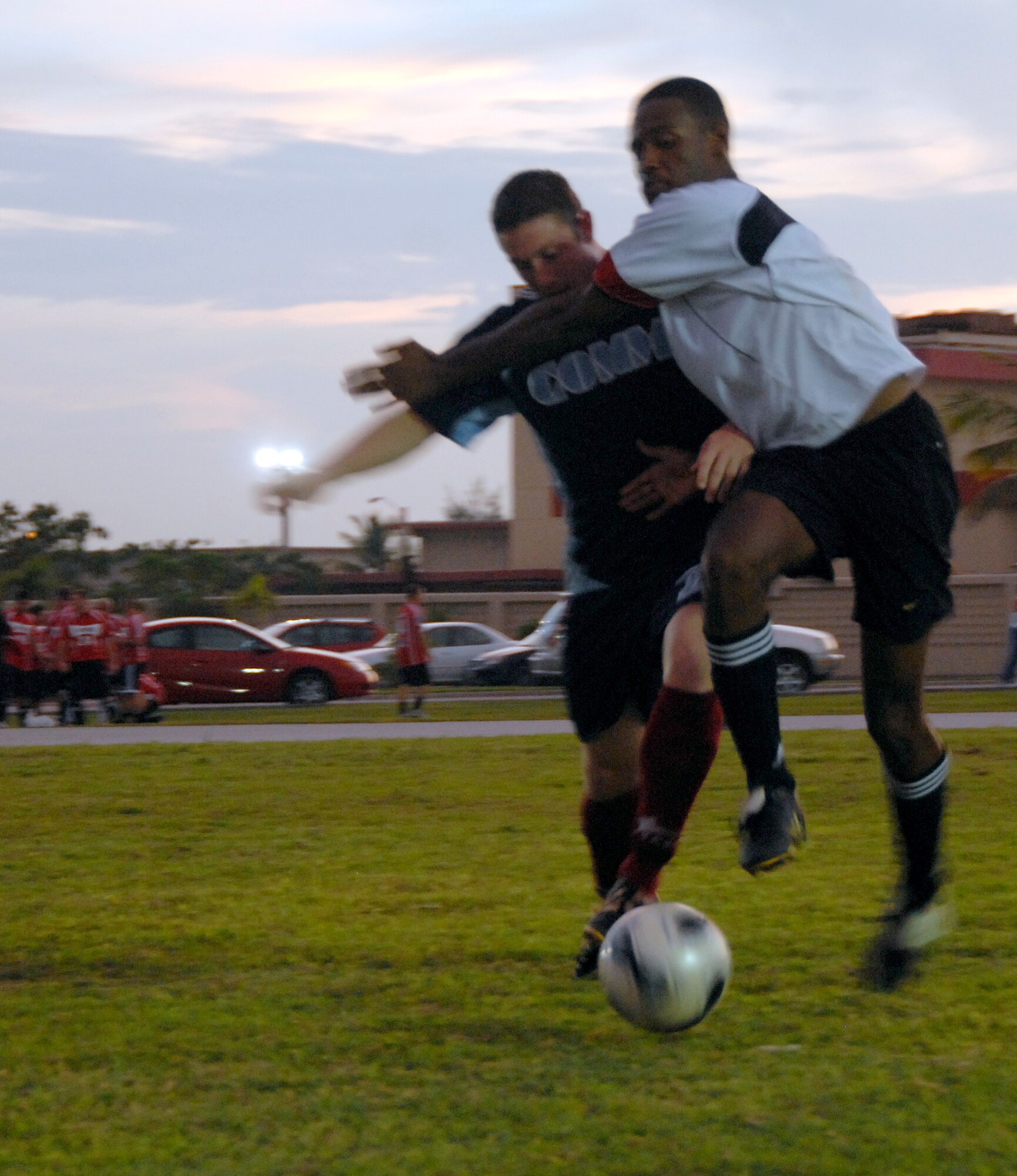 ANDERSEN AIR FORCE BASE, Guam - A Helicopter Sea Combat Squadron TWENTY-FIVE player blocks Senior Airman Sonny Carlos, from the 36th Communications Squadron, in intramural soccer Aug. 28 at Andersen's soccer field. (Photo by Airman 1st Class Daniel Owen/36th Wing Public Affairs)
