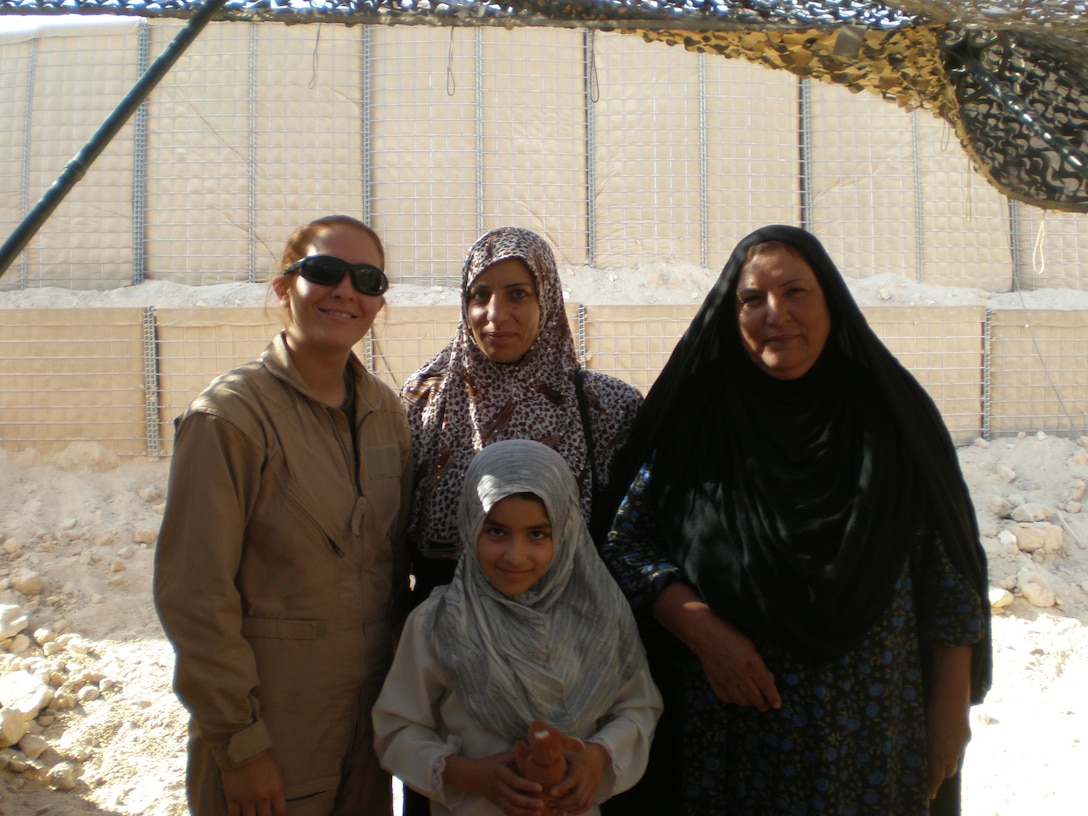 Cpl. Jennifer D. Uriostegui stands with three Iraqi females during her 2006 deployment to Al Asad, Iraq.