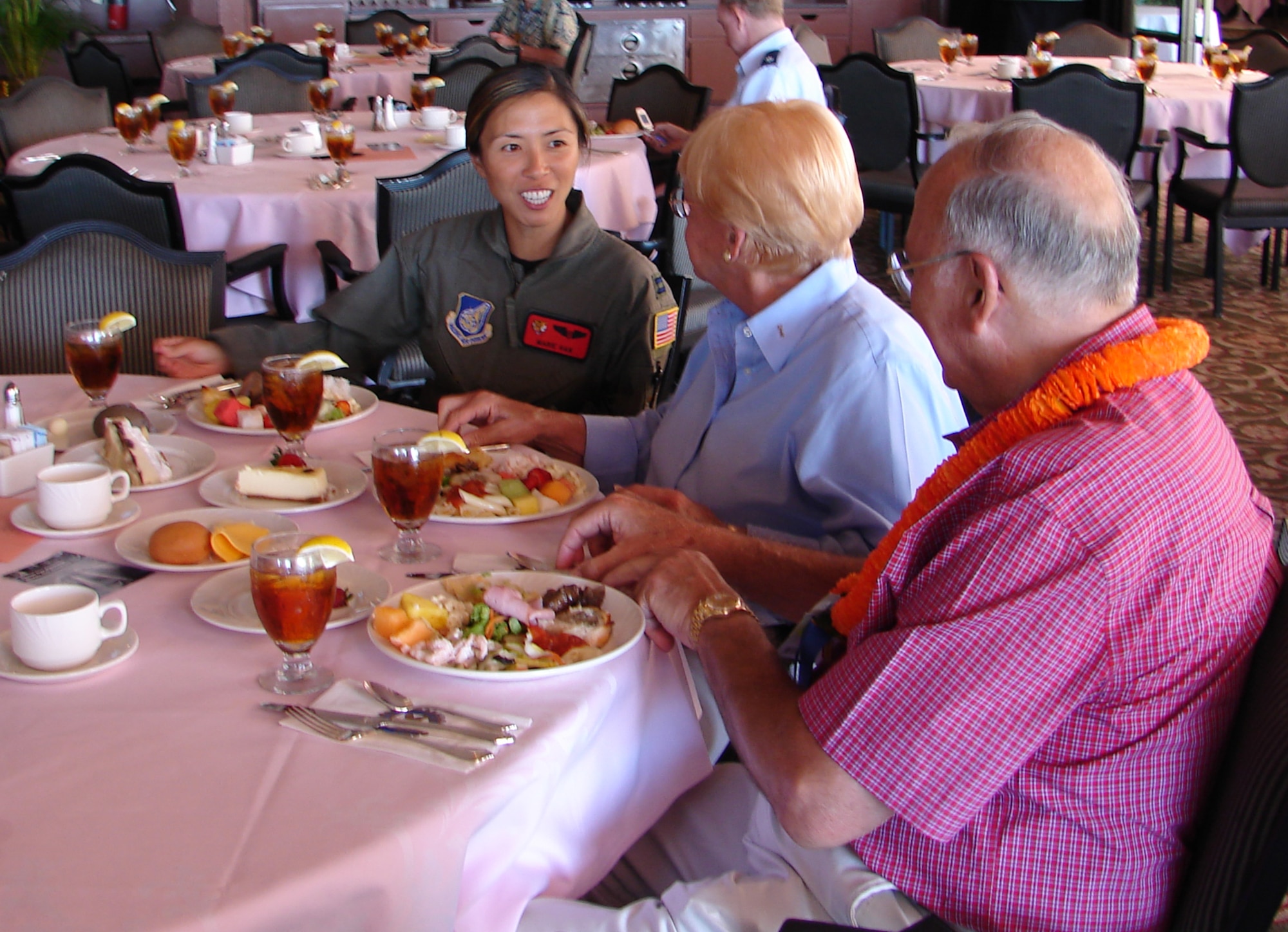 WAIKIKI -- Captain (Dr.) Marie Han, flight surgeon with the 535th Airlift Squadron, talks with Dr. Kenneth and Colleen Shanklin Sept. 4, 2007, at the Rotary Club of Honolulu luncheon at the Royal Hawaiian Hotel in Waikiki. Gen. Paul V. Hester, Pacific Air Forces Commander, was the guest speaker and recognized four Airmen who represent the total force. He also explained to the club members the strategic importance of Guam, and the upcoming Air Force Week Honolulu activities. (U.S. Air Force photo by Capt. Allison Farabaugh) 