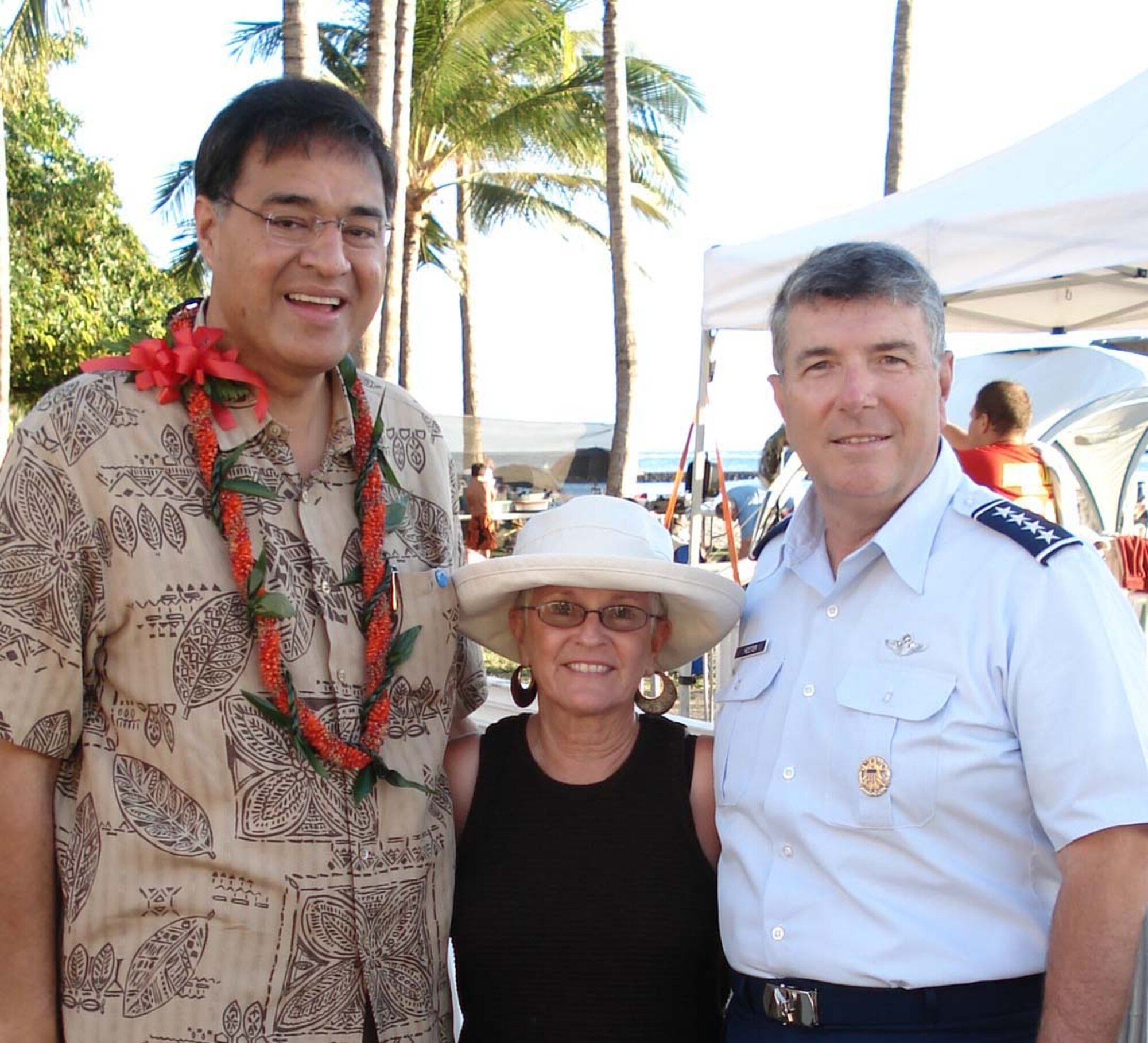 HONOLULU, Hawaii -- Mayor Mufi Hannemann (left), poses with General and Mrs. Paul V. Hester on Waikiki Beach during Sunset on the Beach. Mayor Hannemann provided remarks prior to the movie, highlighting the Air Force's 60th Anniversary.  Gen. Hester, Pacific Air Forces commander, invited the communitity to upcoming Air Force Week Honolulu events. (U.S. Air Force photo by PACAF/Public Affairs staff)