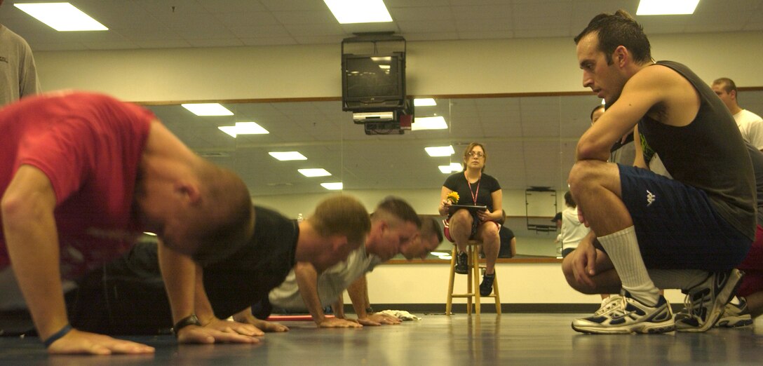 ANDERSEN AIR FORCE BASE, Guam - Senior Airman Jack Boubelik, from the 36th Operations Support Squadron, counts push ups for the 736th Security Forces Squadron during Andersen's Fitness Challenge Sept. 1 at the fitness center. Airman Boubelik was one of the competitors on the 36th OSS team.  Senior Airman Bryan Nagy, 644th Combat Communications Squadron, won the push up competition. Three five-man teams competed in the challenge.  Individuals were measured in five categories: abdominal circumference, three mile run, sit and reach, push ups and sit ups.  The fitness center staff averaged the scores to determine which team was the overall winner.  The 736th Security Forces Squadron won the fitness challenge.  