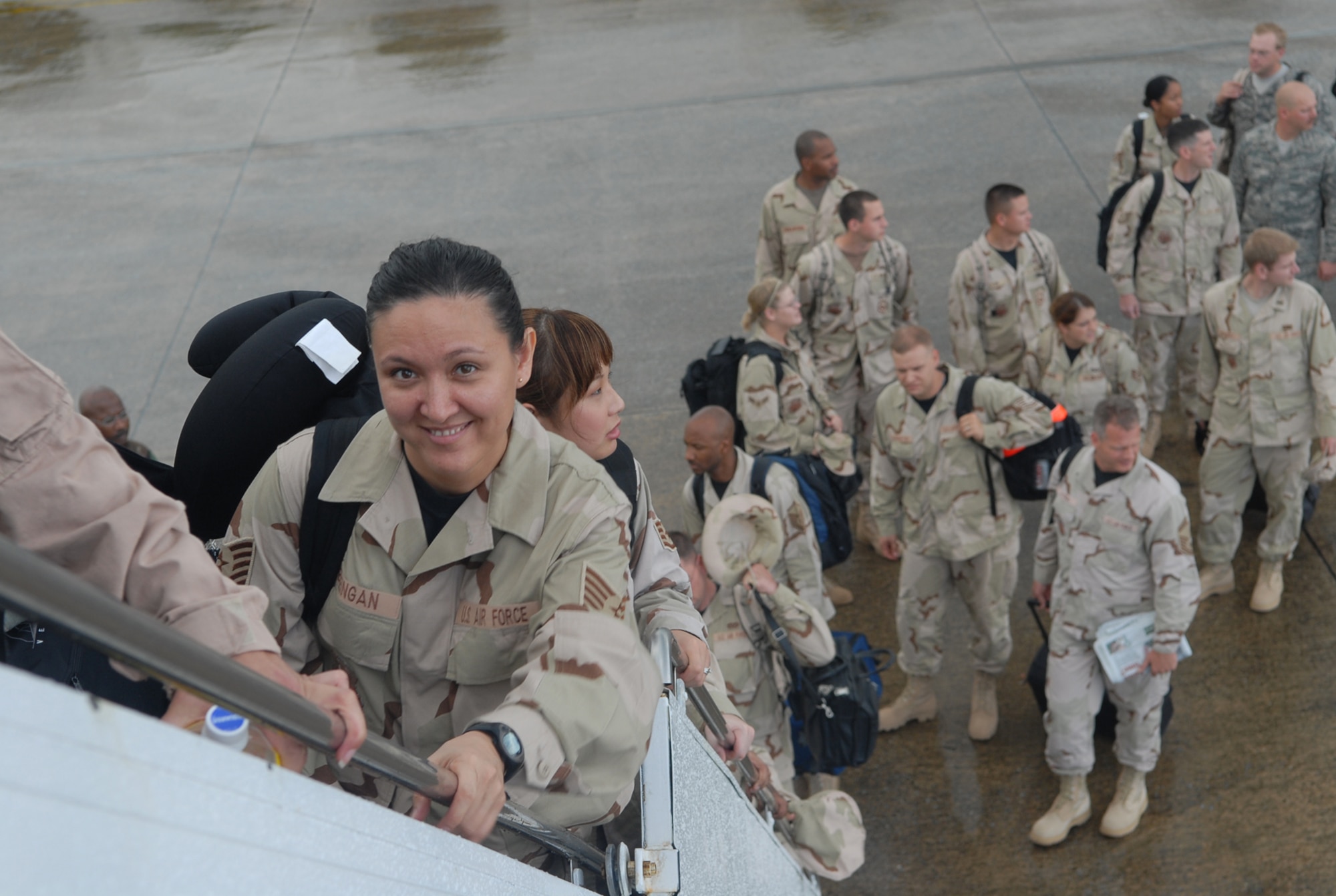 Tech. Sgt. Cathy Breingan boards a contract aircraft at Kadena Air Base, Japan, Sept. 2, 2007.  More than 240 Airmen from seven bases in Pacific Air Forces left Kadena for Southwest Asia to support operations Iraqi Freedom and Enduring Freedom.  Sergeant Breingan is assigned to Headquarters PACAF at Hickam Air Force Base, Hawaii.  U.S. Air Force photo/Maj. Dani Johnson