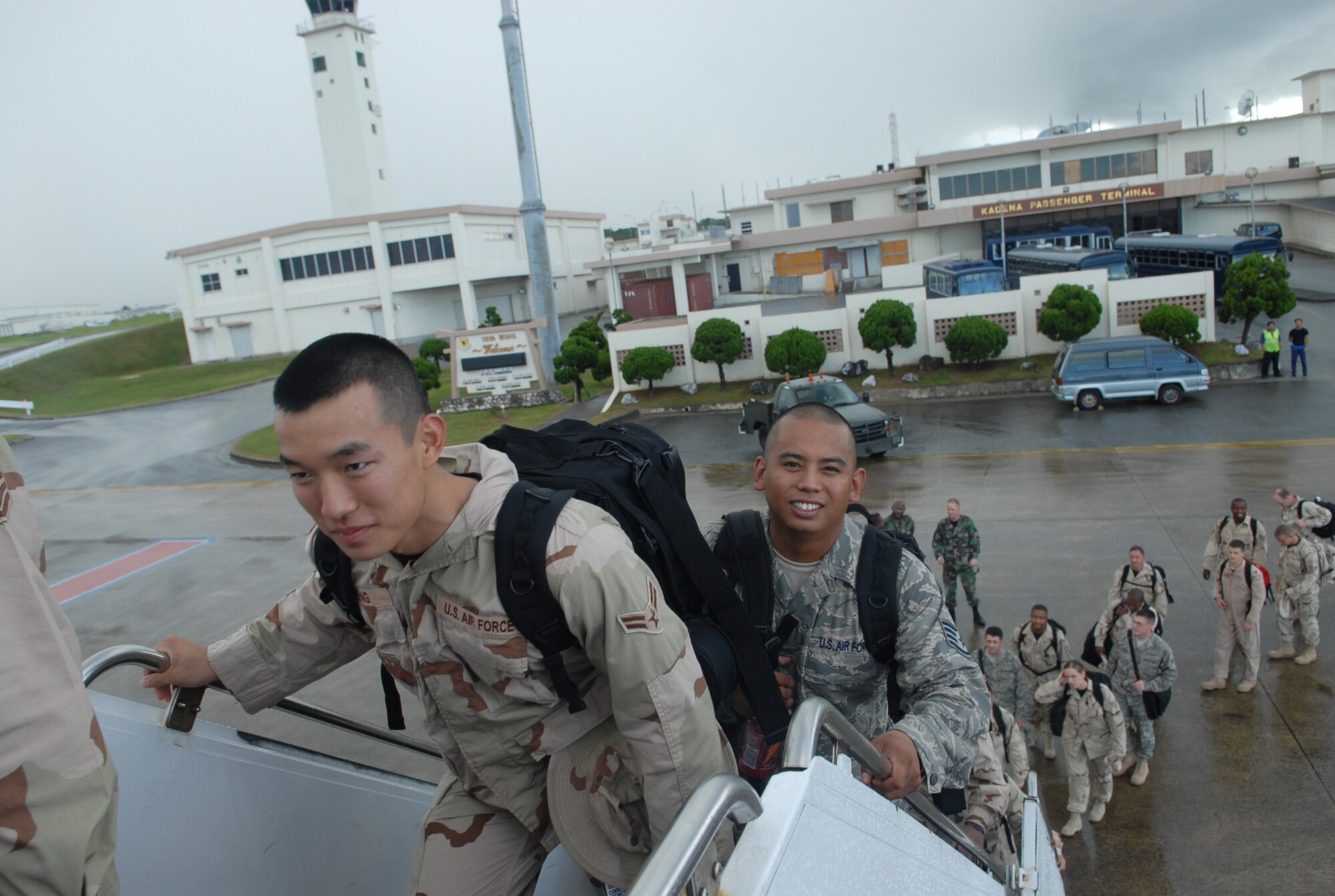 Airman 1st Class David Zheng and Staff Sgt. Joshua Garcia board a contract aircraft at Kadena Air Base, Japan, Sept. 2, 2007.  More than 240 Airmen from seven bases in Pacific Air Forces left Kadena for Southwest Asia to support operations Iraqi Freedom and Enduring Freedom.  Both Airmen are assigned to 18th Wing Public Affairs.  U.S. Air Force photo/Maj. Dani Johnson