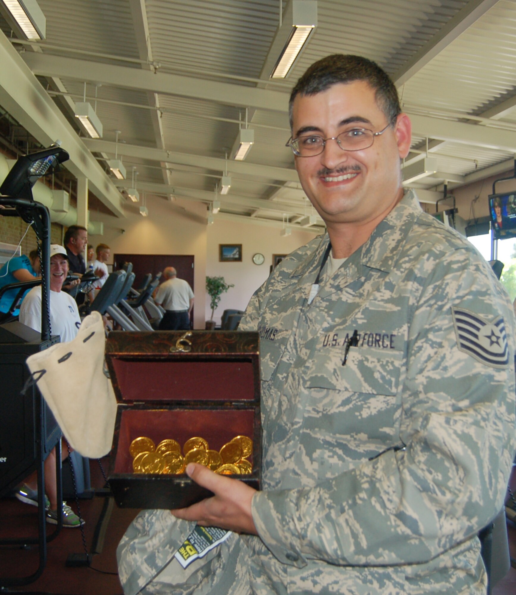 Tech. Sgt. Donald Thomas shows off the treasure chest he found as part of the Amazing Base Sept. 4. Sergeant Thomas was the first to win money through the promotion, which will give out $100 three times a week from Sept. 4 to Oct. 26. (U. S. Air Force photo by Corey Dahl)
