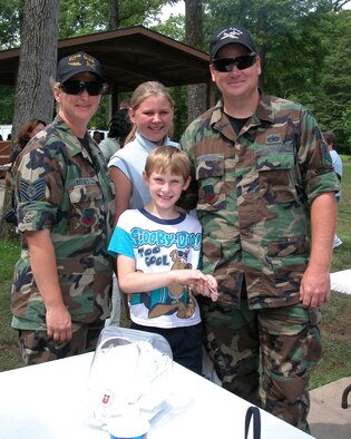 Senior Master Sgts. Bonnie and Hollis Reeves (pictured here as technical sergeants) and their children at Family Day 2003. (U.S. Air Force photo/Staff Sgt. Sherri Savant)