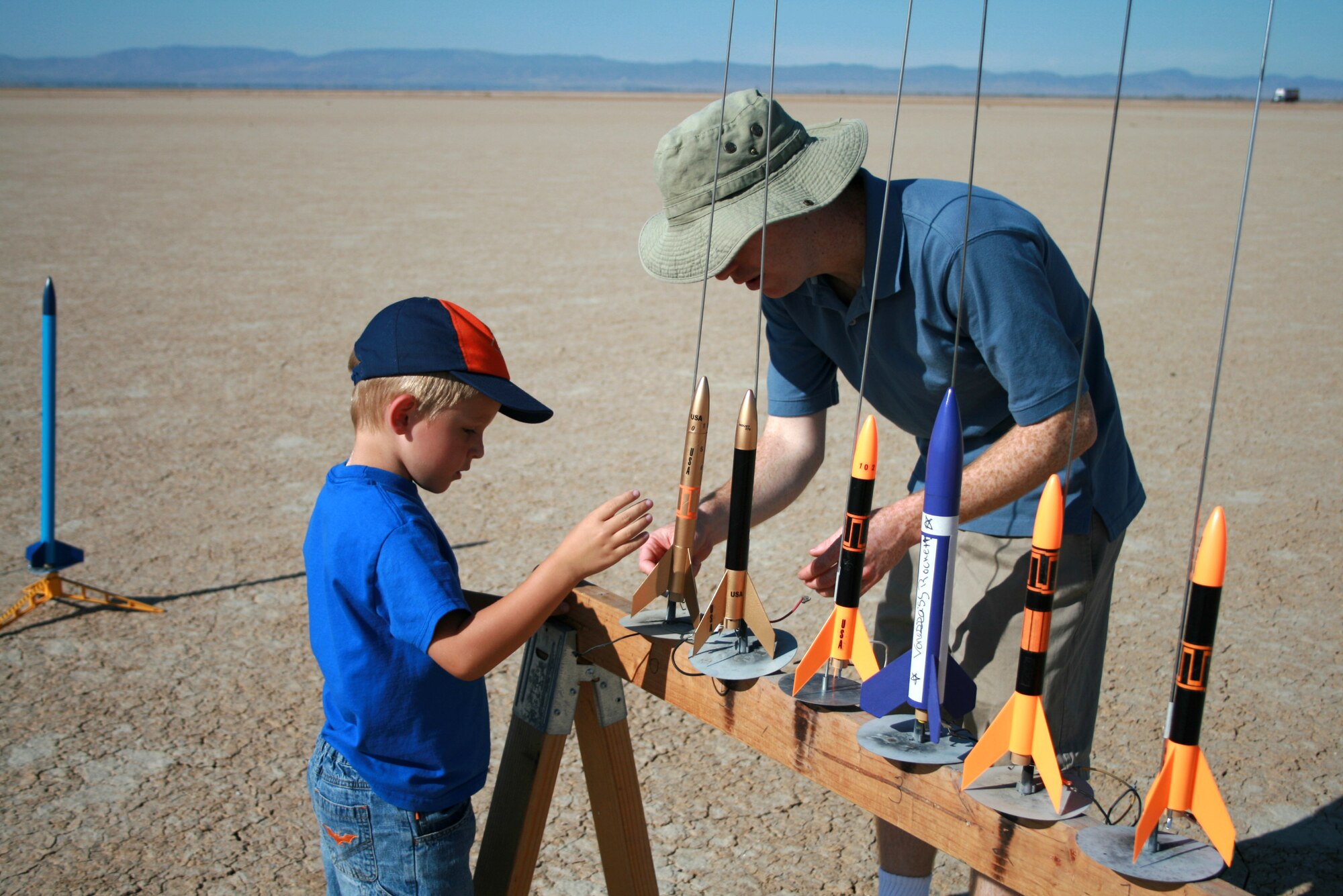 Logan Rotramel, a Cub Scout from pack 741, assists Capt. Stephen Leggario, Cub Scout leader, during a recent rocket lauch on the Rosamond Dry Lake. The rocket launch is one of many activities the Cub Scouts participate in throughout the year to have fun and earn merit badges. (Courtesy photo)